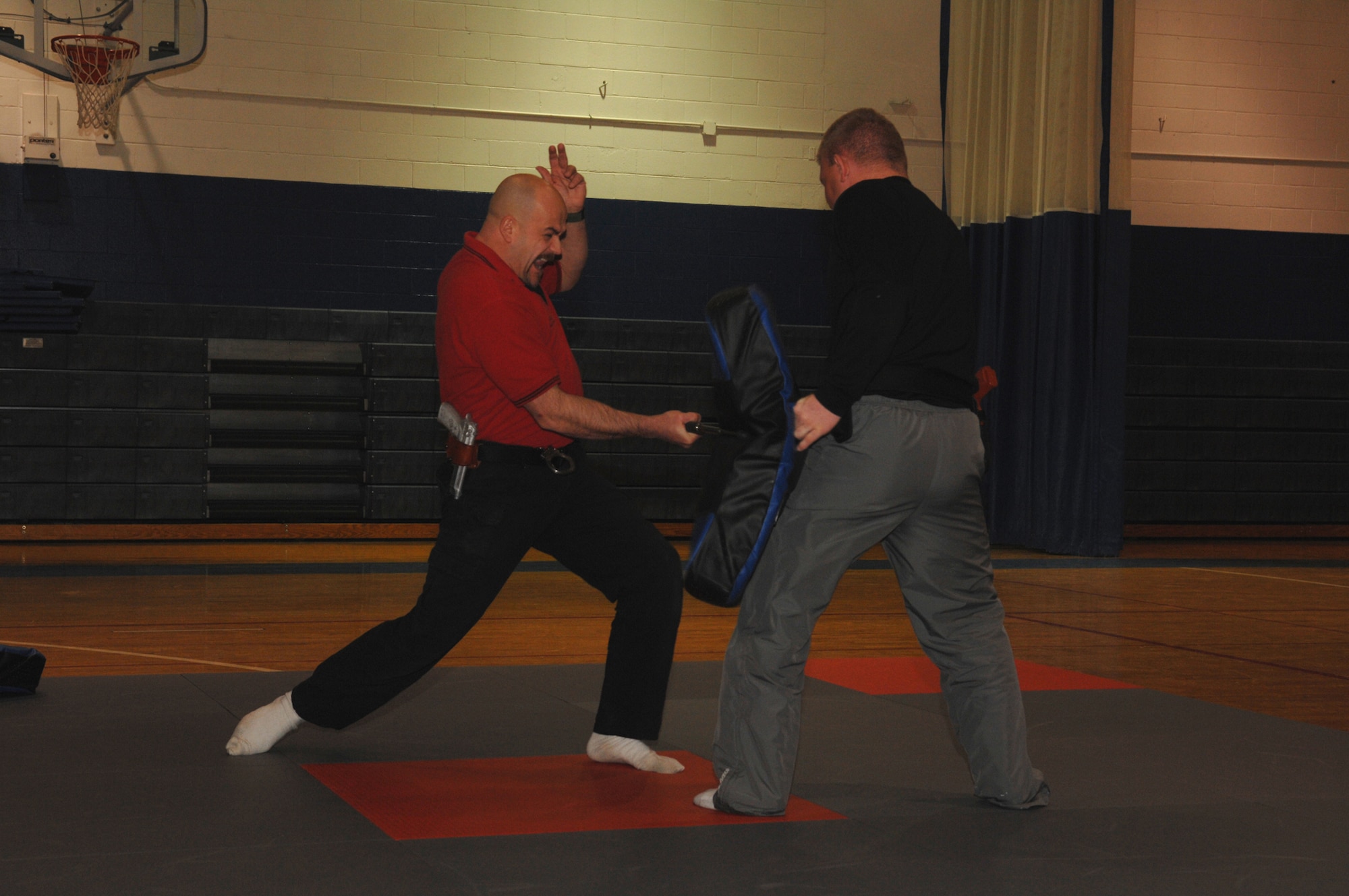 WHITEMAN AIR FORCE BASE, Mo-- Self Defense instructor Billy Matheny, 509th Security Forces demonstrates a forward strike while Officer Colt Callison, Chenega Company, holds the striking shield, Feb. 20. This class is part of 70 hours of training that all new civilian security officers are required to have upon being hired. (U.S. Air Force photo/ Senior Airman Stephanie Clark)