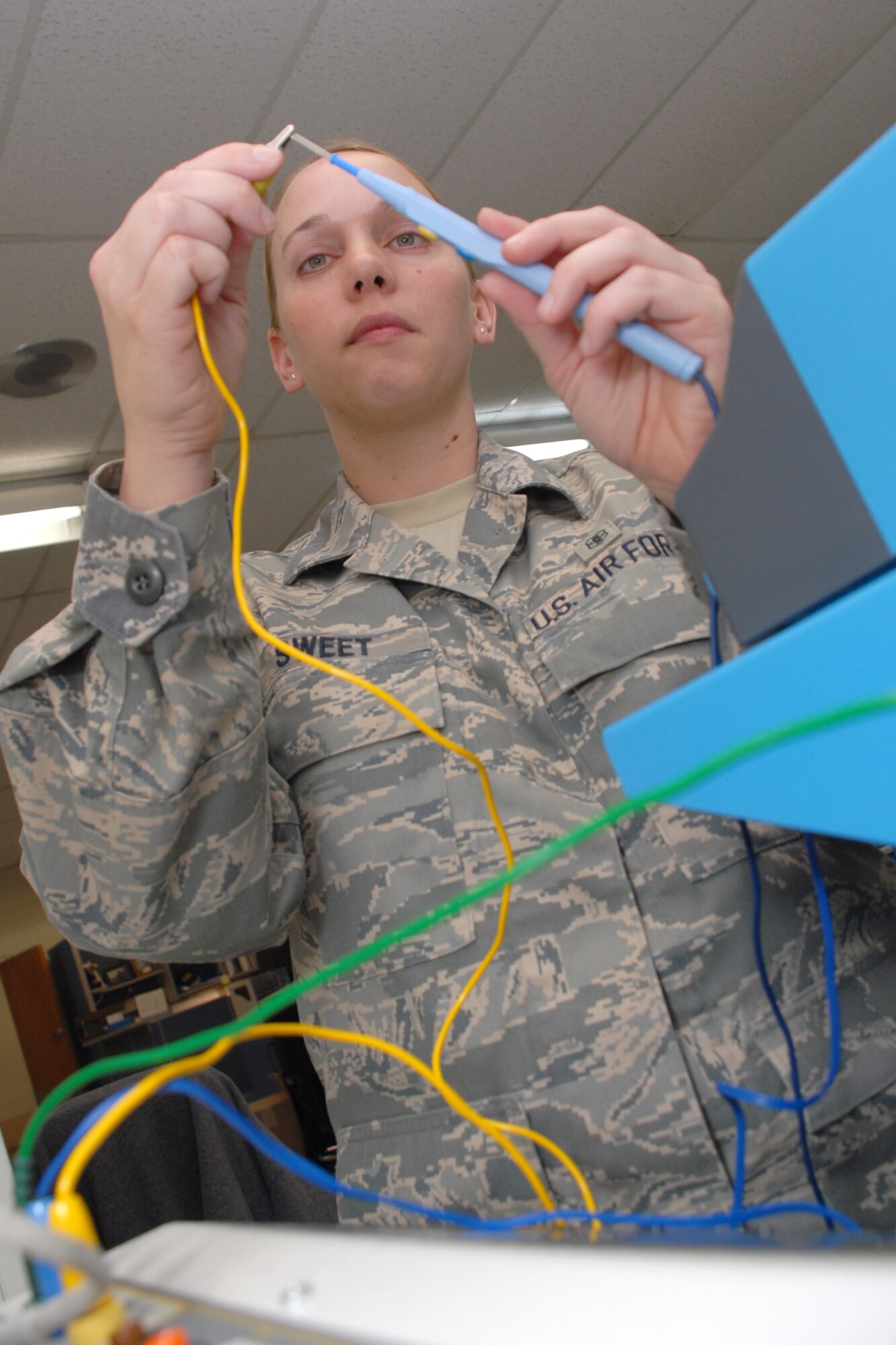 EGLIN AIR FORCE BASE, Fla. -- Senior Airman Karen Sweet, 96th Medical Support Squadron biomedical equipment technician, test the functionality of a electrosurgical analyzer used in operating rooms to cauterize inscissions. The staff sergeant select was recently awarded as the U.S. Air Force Outstanding Biomedical Equipment Repair Airman of the Year for her skill and professionalism. From uncovering a fault in fetal monitor time synchronization to the mass recall of 127 defibrillators, Airman Sweet tackeled each task with efficiency. She has also been a community ambassodor by delivering more than 400 Meals-on-Wheels to local elderly community. (U.S. Air Force photo by Staff Sgt. Mike Meares)
