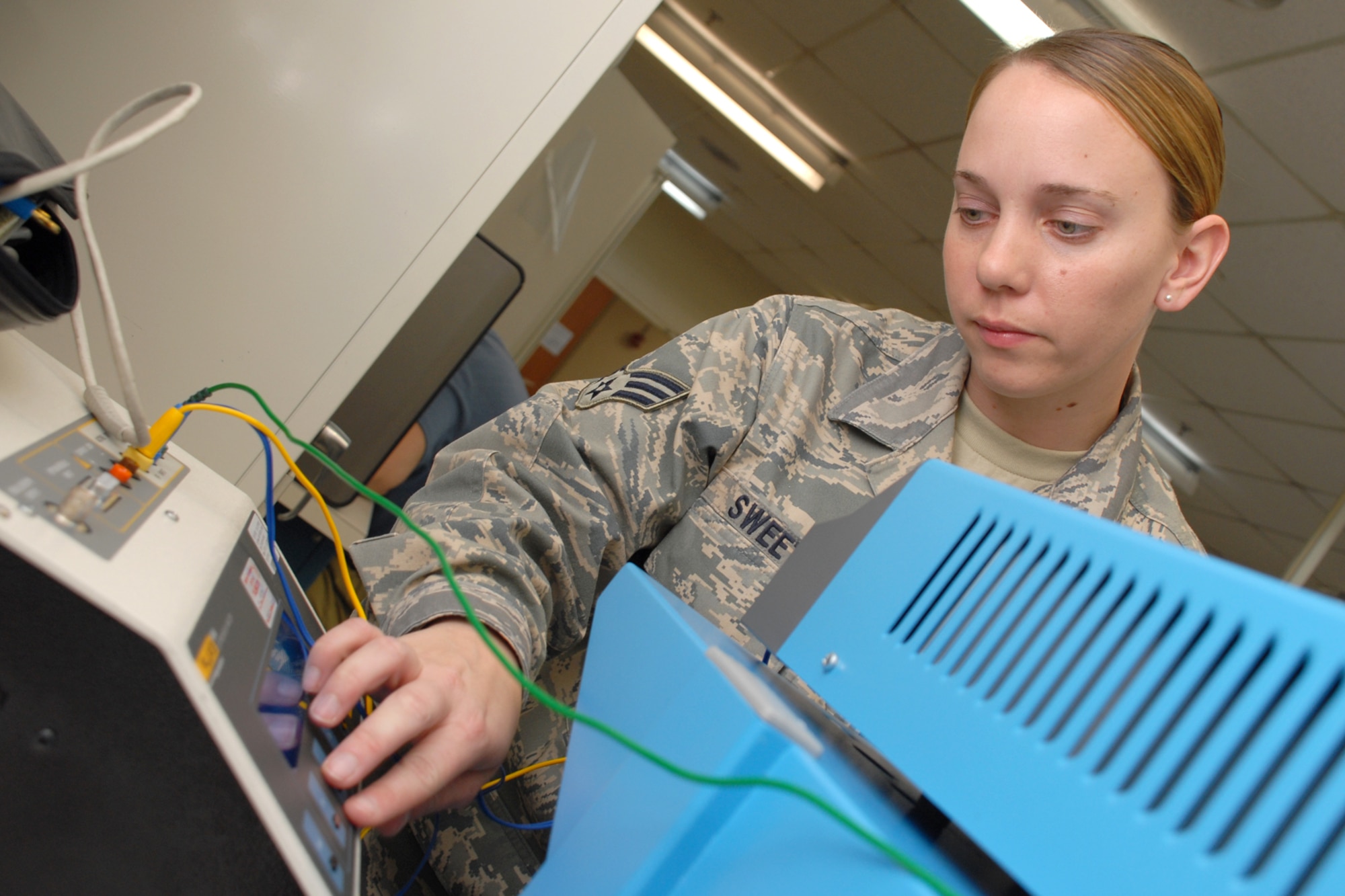 EGLIN AIR FORCE BASE, Fla. -- Senior Airman Karen Sweet, 96th Medical Support Squadron biomedical equipment technician, test the functionality of a electrosurgical analyzer used in operating rooms to cauterize inscissions. The staff sergeant select was recently awarded as the U.S. Air Force Outstanding Biomedical Equipment Repair Airman of the Year for her skill and professionalism. From uncovering a fault in fetal monitor time synchronization to the mass recall of 127 defibrillators, Airman Sweet tackeled each task with efficiency. She has also been a community ambassodor by delivering more than 400 Meals-on-Wheels to local elderly community. (U.S. Air Force photo by Staff Sgt. Mike Meares)