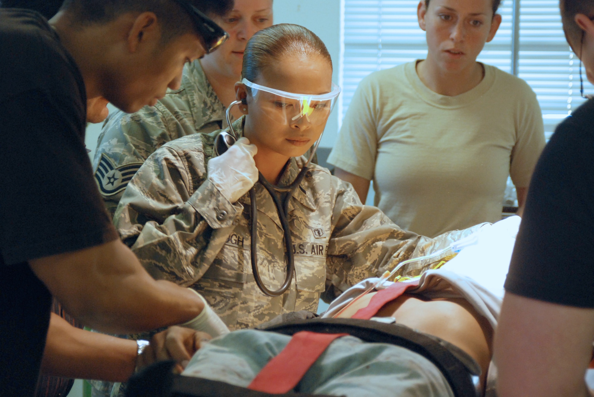1st Lt. Jasmin Furlough ensures an accident victim is stabilized in preparation for medical airlift Feb. 26 from Soto Cano Air Base, Honduras, to Tegucigalpa, Honduras. JTF-Bravo Medical Element staff members responded when asked for assistance by a local civilian hospital after 30 people were injured in a roll-over accident. Lieutenant Furlough is a Joint Task Force-Bravo physician assistant. (U.S. Air Force photo/Tech. Sgt. John Asselin) 
