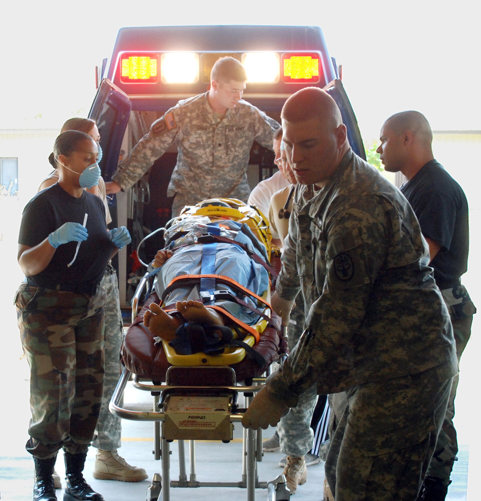 Joint Task Force-Bravo Medical Element staff transport an accident victim from an ambulance to the emergency room Feb. 26 at Soto Cano Air Base, Honduras. JTF-Bravo members assisted local medics after a truck carrying about 30 people rolled over near Comayagua, Honduras. (U.S. Air Force photo/Tech. Sgt. John Asselin) 

