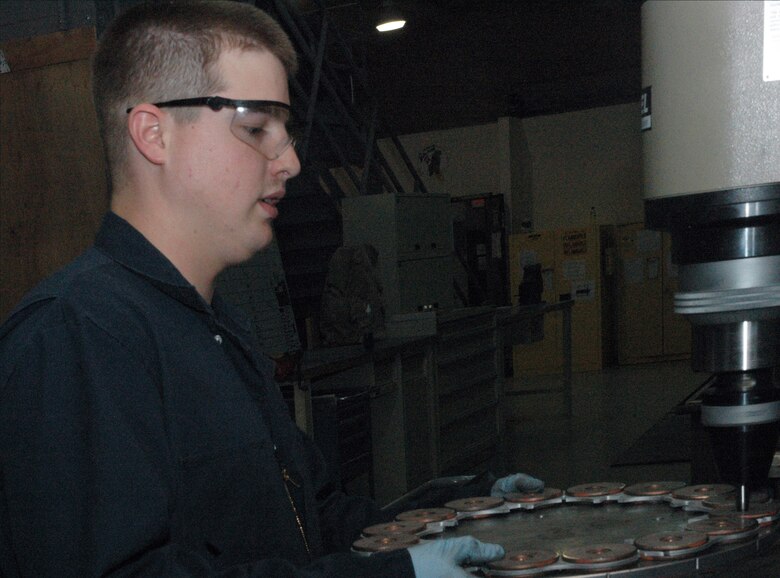 Sgt. Mark Hughes uses a spin riveter to rivet KC-135 Stratotanker brake linings to the brake plates Feb. 25 at the only in-theater central intermediate repair facility in Southwest Asia. The spin riveter compresses the rivet in a spinning motion in order to keep the rivet from cracking. (U.S. Air Force photo/Senior Airman Carolyn Viss) 