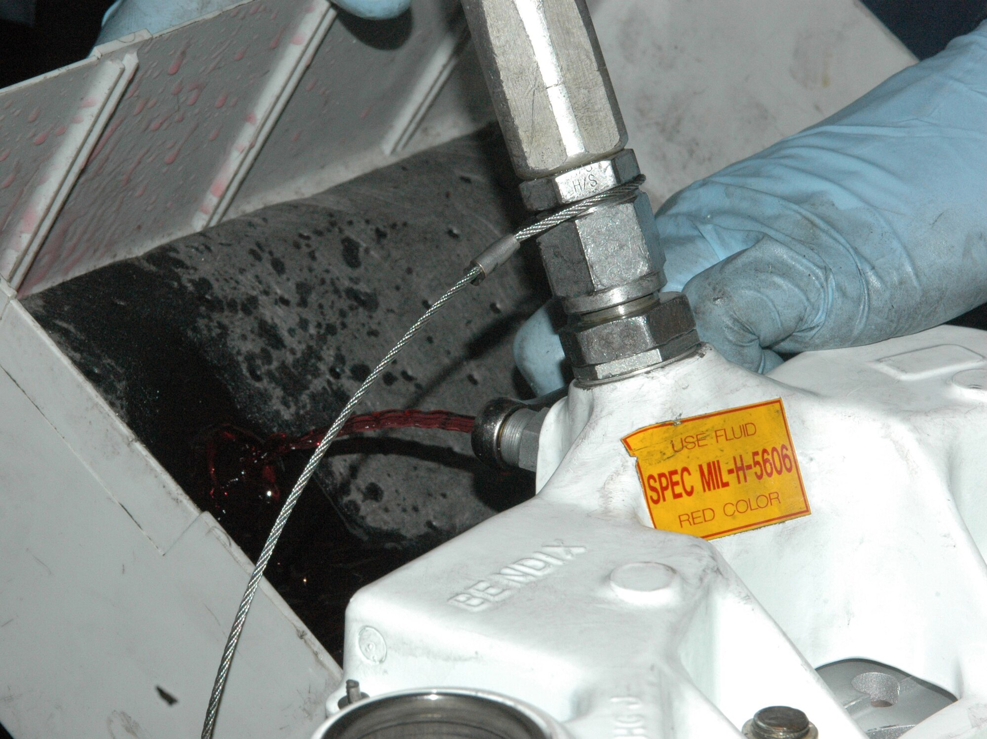 Sgt. Christopher Crespo releases hydraulic fluid from a reassembled brake to test for leaks Feb. 25 at the only in-theater central intermediate repair facility in Southwest Asia. (U.S. Air Force photo/Senior Airman Carolyn Viss) 