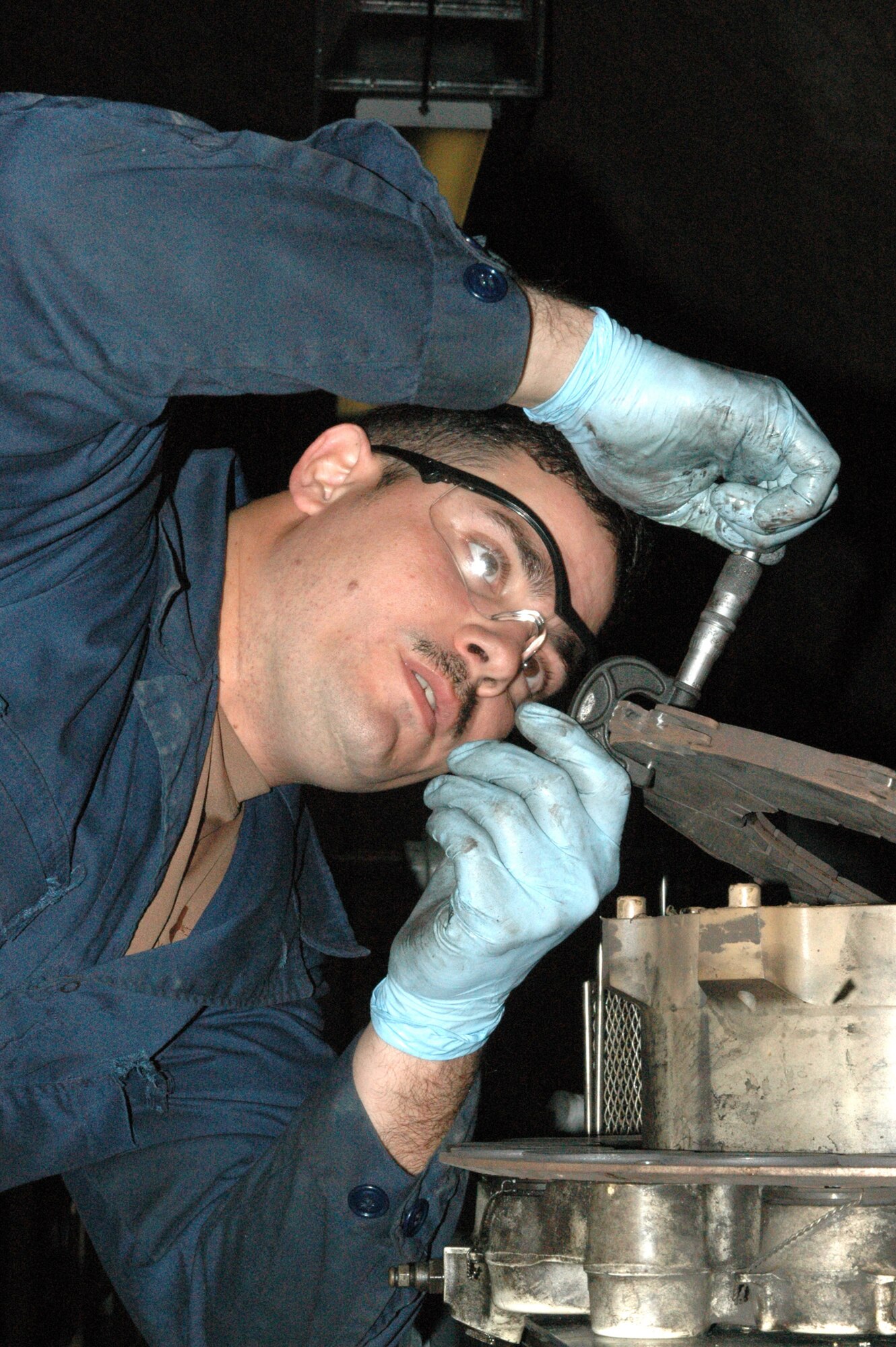 Sgt. Christopher Crespo measures the thickness of a new brake puck on a KC-135 Stratotanker brake Feb. 26 at the only in-theater central intermediate repair facility in Southwest Asia. The CIRF makes it possible for the brakes on KC-135s to be repaired immediately, saving time and money that would be spent shipping the parts to and from the United States. (U.S. Air Force photo/Senior Airman Carolyn Viss) 