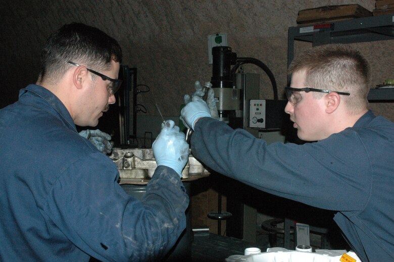 Staff Sergeants Christopher Crespo and Mark Hughes tighten bolts on a 250-pound KC-135 Stratotanker brake Feb. 25 at the only in-theater central intermediate repair facility in Southwest Asia. Both are members of the 379th Expeditionary Maintenance Squadron hydraulics flight. (U.S. Air Force photo/Senior Airman Carolyn Viss) 