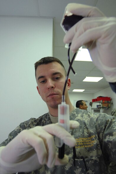 Army Spc. Lamar Elwell draws a sample of whole blood for testing Jan. 28 at the Air Force Theater Hospital at Balad Air Base, Iraq. Before donated blood is administered to patients, a sample is extensively tested to ensure its purity and quality. Specialist Elwell is a 153rd Blood Support Detachment medical lab technician deployed from Fort Lewis, Washington. (U.S. Air Force photo/Senior Airman Julianne Showalter) 