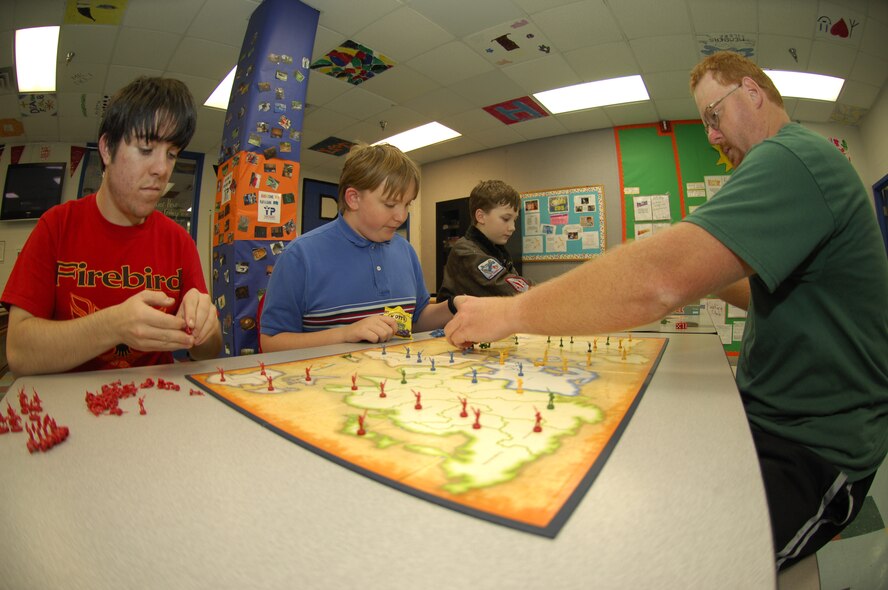 MOODY AIR FORCE BASE, Ga. -- Members of the Youth Center “Battle Club” set up pieces during a game of Mission Risk here Feb 28. Jason Owen, Youth Center program assistant, meets with the battle club on a regular basis and gets a typical showing of three to six members at each meeting. (U.S. Air Force photo by Senior Airman Elizabeth Rissmiller)