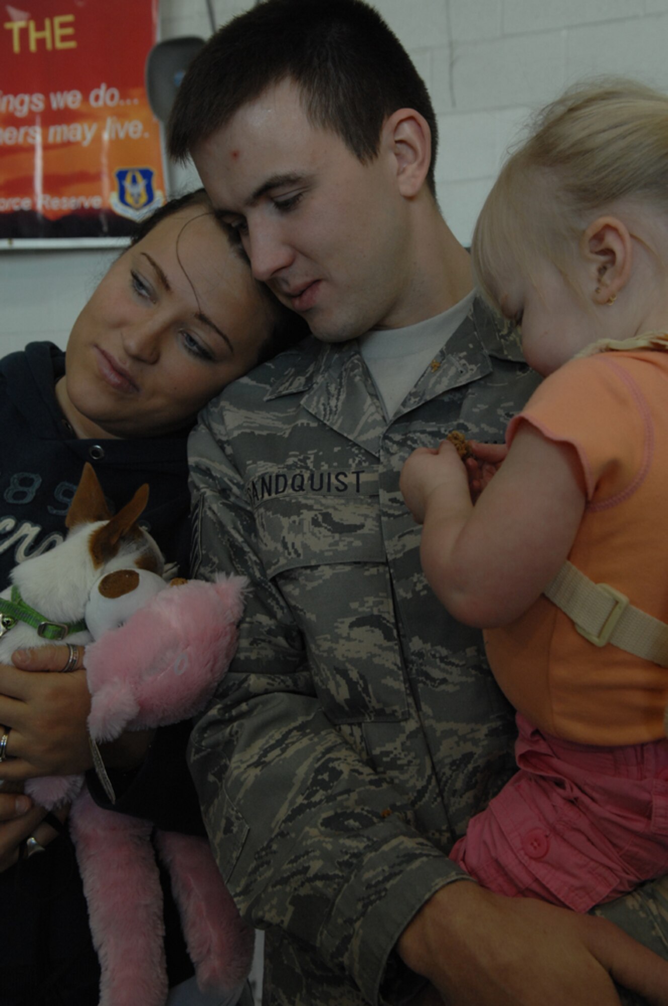 Tech. Sgt. Dustin Sandquist, 943rd Rescue Group, spends a few minutes with his wife, Jill, and daughter, Jade before leaving for a deployment Feb. 28 at Davis-Monthan AFB. The 943rd is an Air Force Reserve unit located here, and is assigned to the 920th Rescue Wing at Patrick AFB Fla. The 943rd RQG trains personnel with equipment, to achieve and maintain the capability to perform day/night combat rescue missions. (U.S. Air Force photo by Senior Airman Christina D. Kinsey)