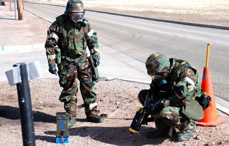 Airman 1st Class Nicholas Firestone, 90th Civil Engineer Squadron, and Staff Sgt. Jared Mays, 90th CES, take air samples during a chemical and biological exercise Feb. 21 (U.S. Air Force photos/Staff Sgt. Chad Thompson).