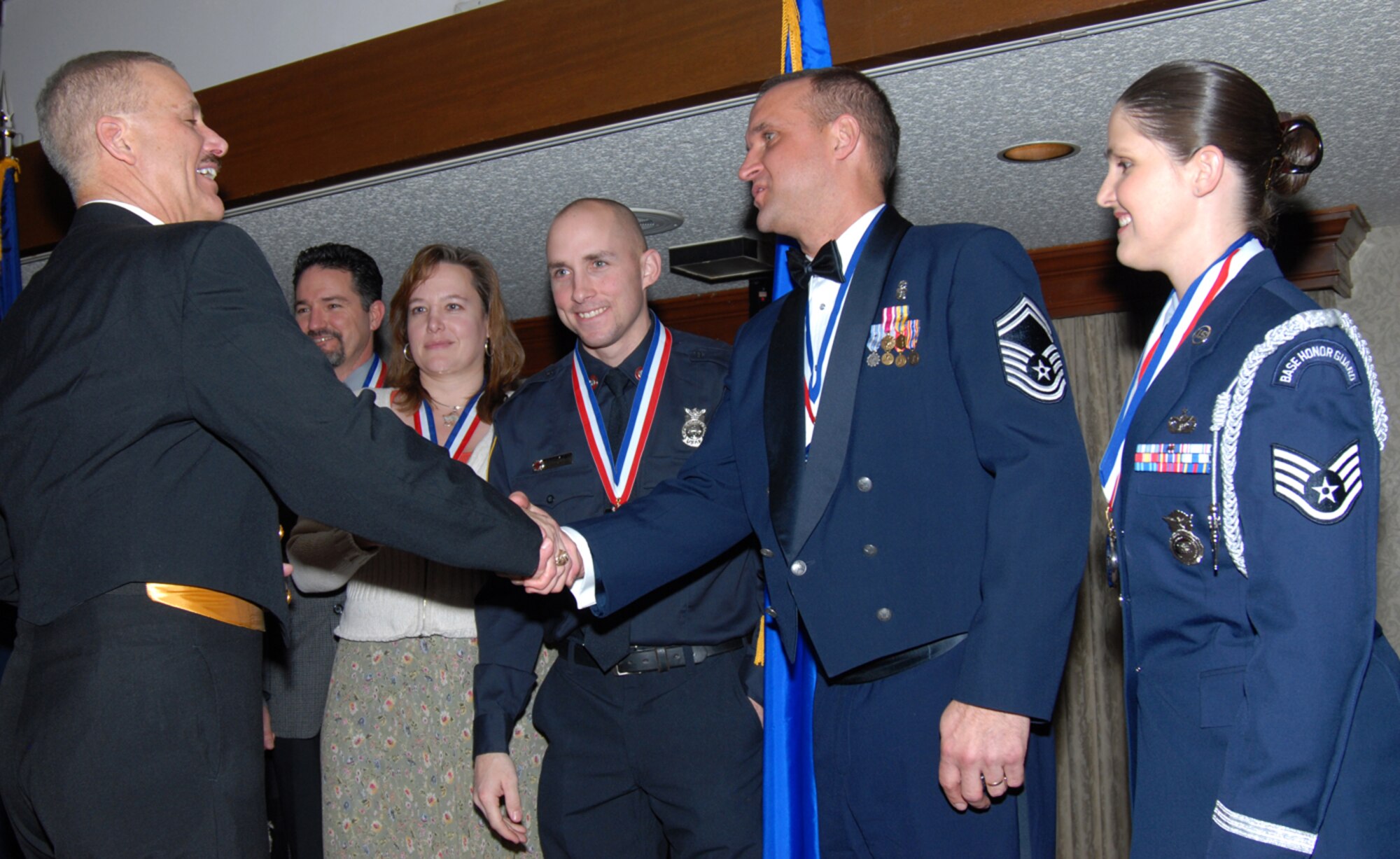 Fleet Command Master Chief Petty Officer William N. Nissen, United States Strategic Command command master chief, congratulates Senior Master Sgt. Curtis Kinnick, Warren’s senior NCO of the year, and the winners of the 90th Space Wing annual awards Saturday. More than 200 Warren members attended the banquet honoring the winners and nominees (U.S. Air Force photo/Bernie Ernst).
