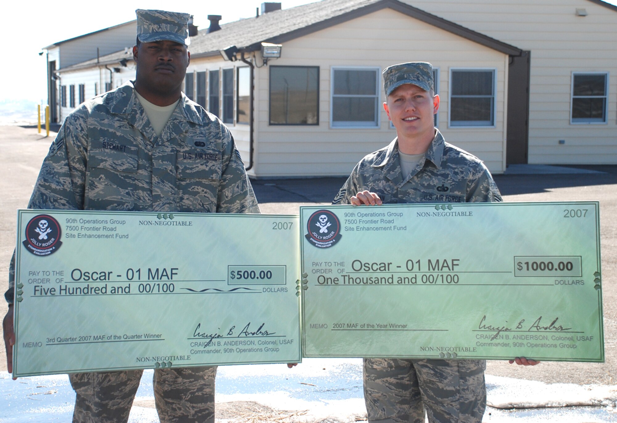 Oscar-01 earned the 90th Space Wing missile alert facility of the year award for 2007. Senior Airman Fredrick Stewart, 321 Missile Squadron, holds the $500 check they won for the third quarter, and Tech. Sergeant Trenady Offermann, 321st MS, holds the $1,000 check they won for MAF of the year. Airman Stewart is the senior chef at Oscar-01, and Sergeant Offermann is the senior facility manager (U.S. Air Force photo/Staff Sgt. Chad Thompson).