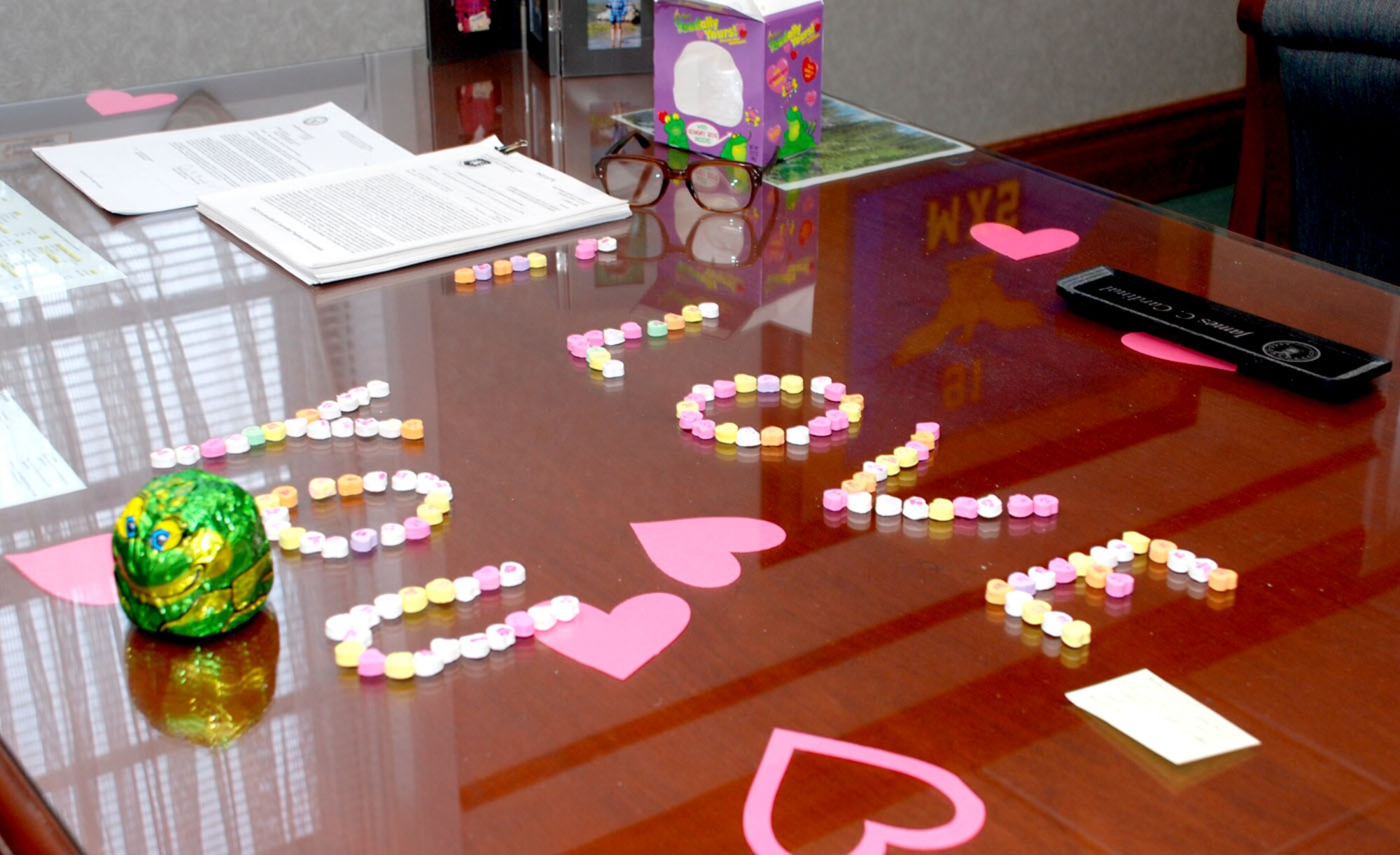 Lori Cardinal, wife of Lt. Col. James Cardinal, 90th Maintenance Group deputy commander, decorated his office Feb. 13 for Valentine’s Day. A paper trail of hearts and cupids lead from outside Bldg. 250 to Colonel Cardinal’s office. Colonel Cardinal had decorated Mrs. Cardinal’s vehicle with a similar surprise tactic (U.S. Air Force photo/Airman 1st Class Daryl Knee).
