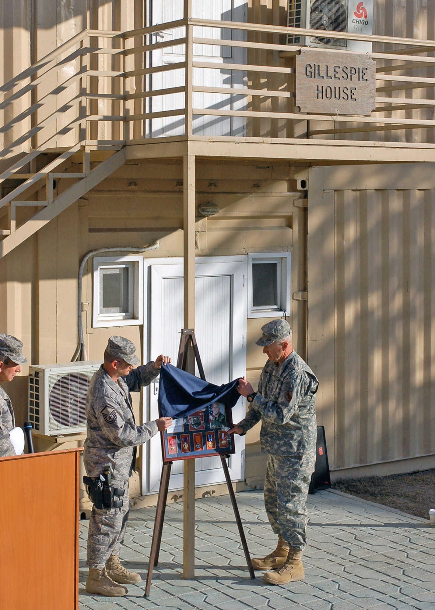 Master Sgt. Josh Crump (left) and Army Maj. Gen. Robert Cone unveil a plaque during a memorial dedication to a fallen Airman March 2 at Camp Eggers, Afghanistan. Master Sgt. Randy Gillespie was killed in action in July 2007 while serving as an embedded training team senior mentor with the Afghan national army 207th Corps in Herat. General Cone is the Combined Security Transition Command-Afghanistan commanding general. (U.S. Air Force photo/Staff Sgt. Robert Wollenberg) 
