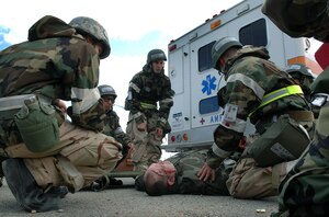 LANGLEY AIR FORCE BASE, Va. -- Airmen of the 1st Medical Group perform self-aid buddy care on a simulated war patient during a Phase II Operational Readiness Exercise Feb. 27. After assessing the patient’s injury, the group transferred the patient to the casualty collection point to successfully complete the training exercise, where Airmen were tested on their ability to survive and operate in a deployed environment. (U.S. Air Force photo/Senior Airman Vernon Young)