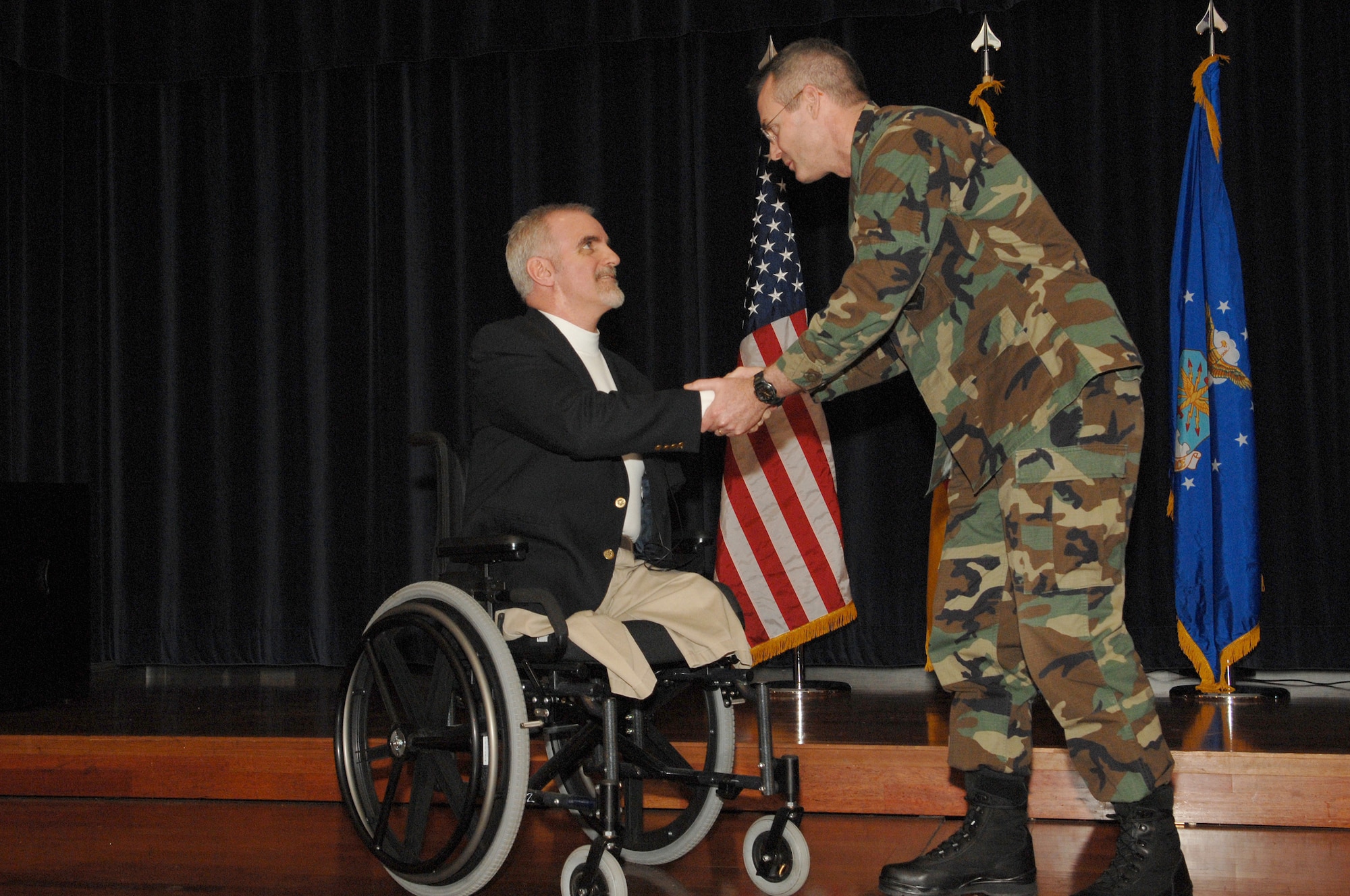 SPANGDAHLEM AIR BASE, Germany – Col. Darryl Roberson, 52nd Fighter Wing commander, thanks Bob Mortimer, a motivational and ministry speaker, for sharing his story with the 52nd Fighter Wing Feb. 29, 2008. Mr. Mortimer lost both legs and an arm after being electrocuted following a car accident. He travels around the globe telling his story to help to encourage people and let them know that they can do great things. (U.S. Air Force photo/Senior Airman Logan Tuttle)