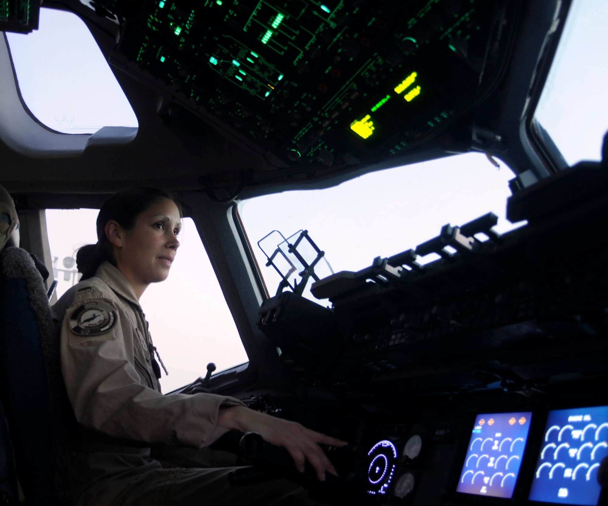 SOUTHWEST ASIA -- 1st Lt. Jessica Lopez in the cockpit of a C-17A Globemaster III Feb. 13. Lieutenant Lopez, a pilot from Charleston Air Force Base, S.C., flies airlift missions over Iraq and Afghanistan from her deployed location in Southwest Asia. (U.S. Air Force photo/Senior Airman Domonique Simmons)
