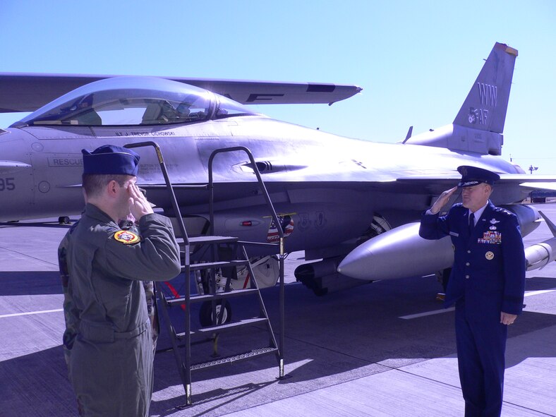 YOKOTA AIR BASE, Japan -- First Lt. Jonathan Cichowski, 13th Fighter Squadron pilot, salutes Lt. Gen. Bruce Wright, former 5th Air Force commander, as he assumes control of the former 5th AF flagship from General Wright at Yokota Air Base Feb. 25. The new 5th AF flagship is a C-130. (U.S. Air Force photo by Col. Eric Schnaible)