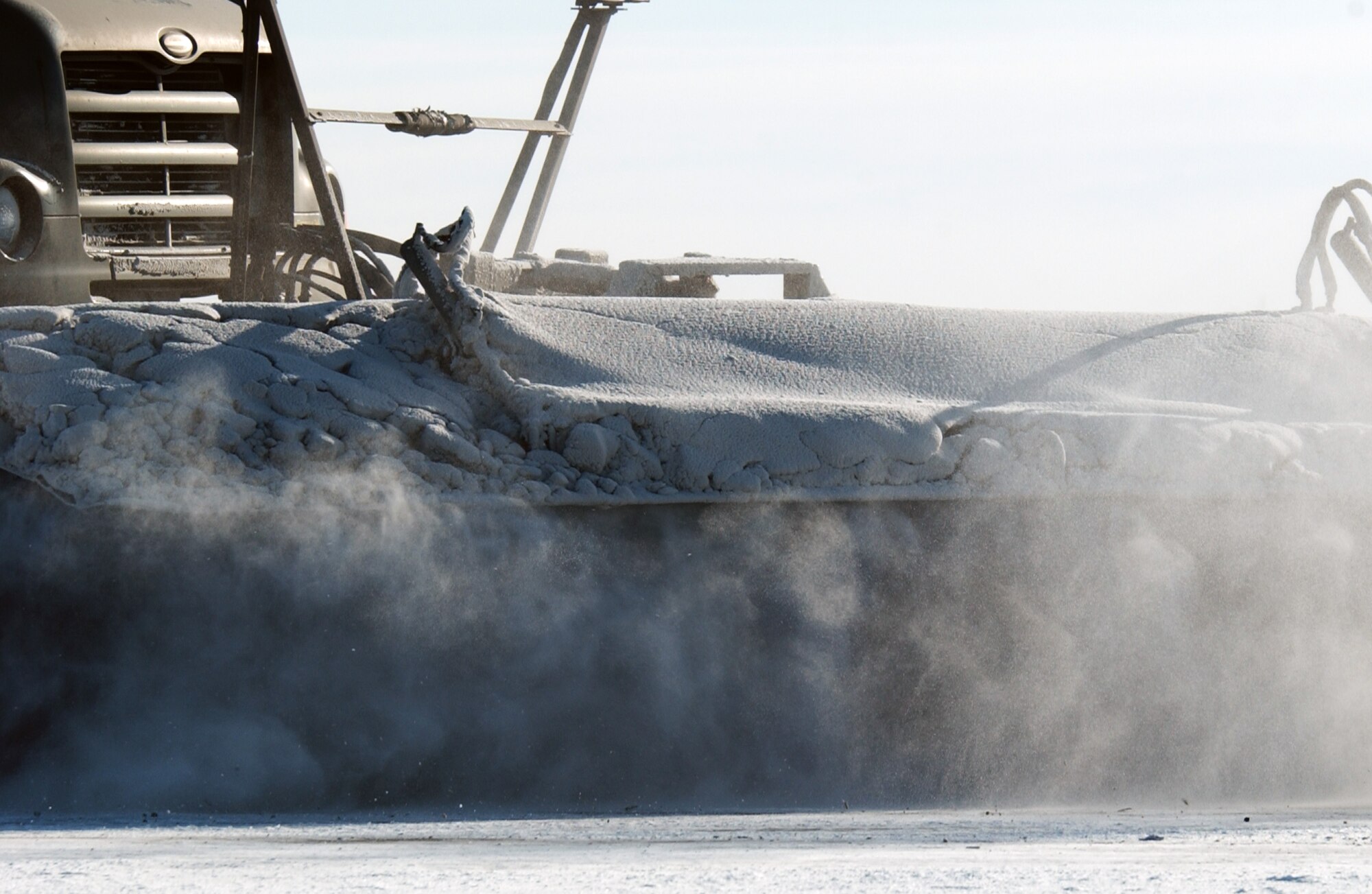 A 354th civil Engineer Squadron airfield broom truck clears the flightline of snow and ice Mar. 3 at Fort Wainwright, Alaska. Airmen of the squadron's horizontal construction flight aided nearby FWW in clearing the runway for C-17 Globemaster III and C-5 Galaxy aircraft to land and take off. The transports will deliver Soldiers and their equipment to the Joint Rreadiness Training Center at Fort Polk, La. to prepare them for deployments. (U.S. Air Force Photo/Airman 1st Class Jonathan Snyder)