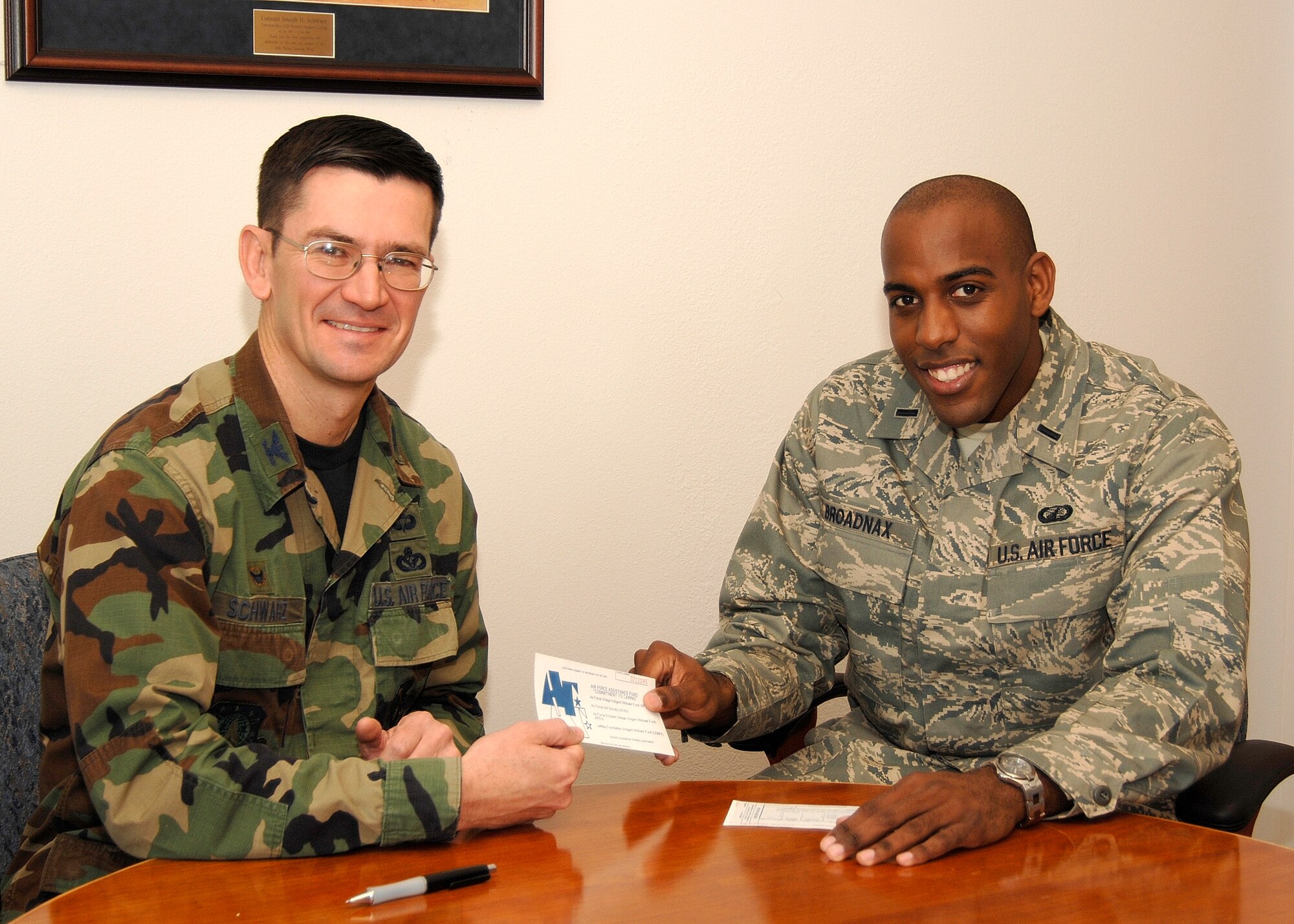 Col. Joseph Schwarz, 61st Air Base Wing commander, receives his AFAF pledge form from Lt. Travis Broadnax. This year’s campaign runs until April 14 (Photo by Lou Hernandez)