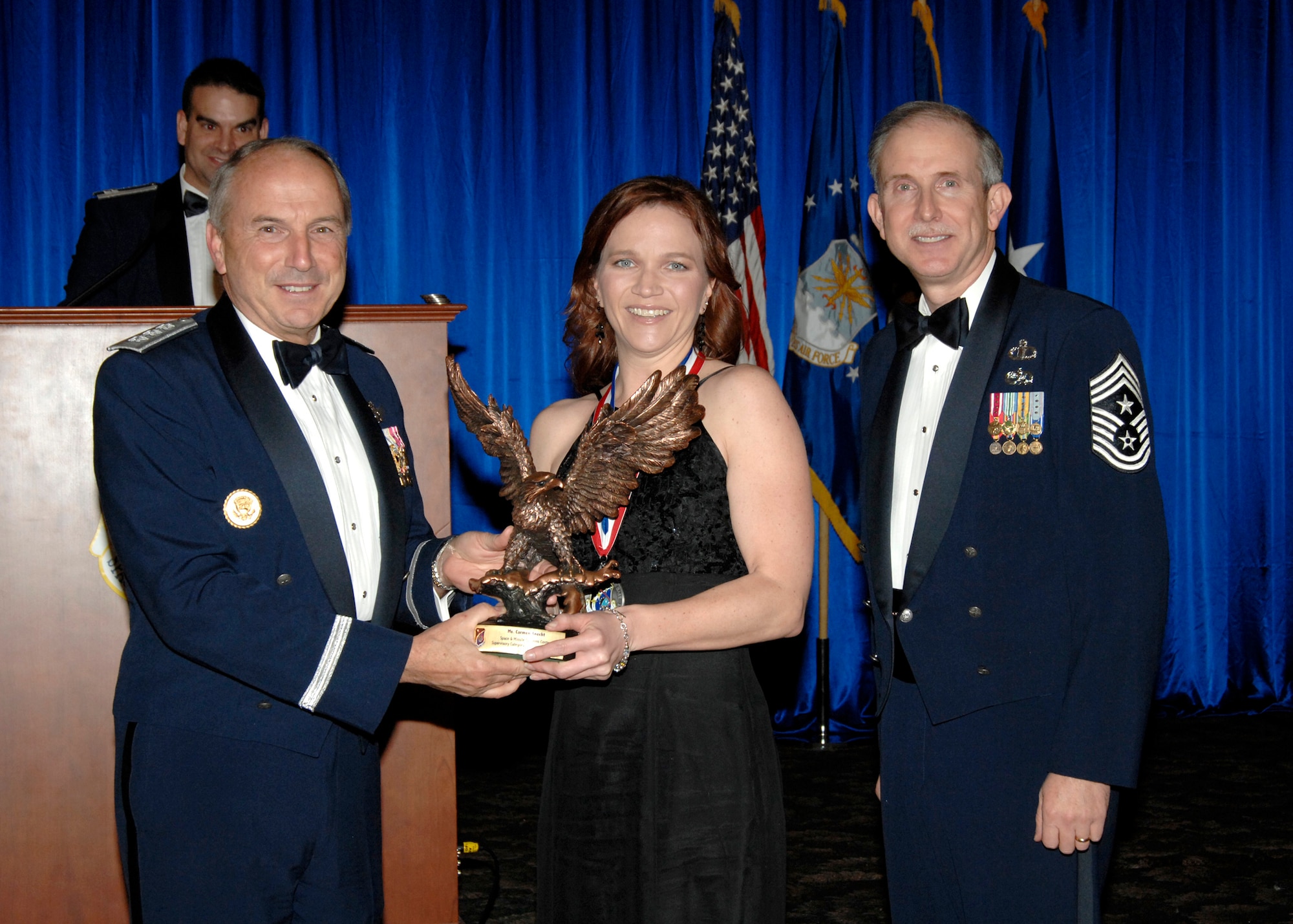 Supervisory Category Civilian of the Year was presented to Carmen Knecht. Also pictured is SMC Commander Lt. Gen.  Michael Hamel and SMC Command Chief Master Sergeant Steven Crocker. (Photo by Lou Hernandez)