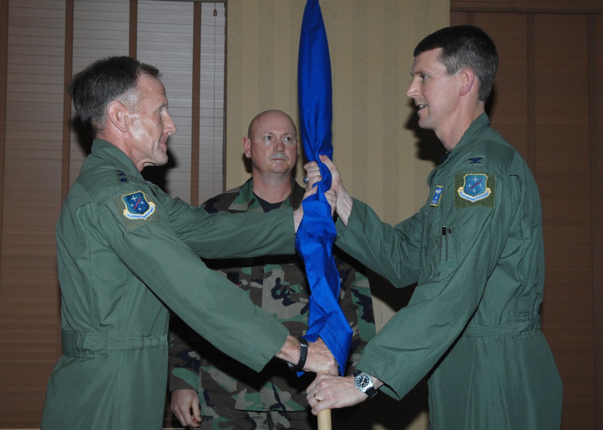 Col. John Marselus (right), the Commander, 612th Air Operations Group, accepts command of the 612th AOG from Lt. Gen. Norman Seip, the Commander, 12th Air Force (Air Forces Southern) during an inactivation and redesignation ceremony at Davis-Monthan Air Force Base, Ariz. The 612th AOG is redesignated the 612th Air and Space Operations Center with Colonel Marselus as the Commander. 
(U.S. Air Force photo/Senior Airman Christina D. Kinsey)
