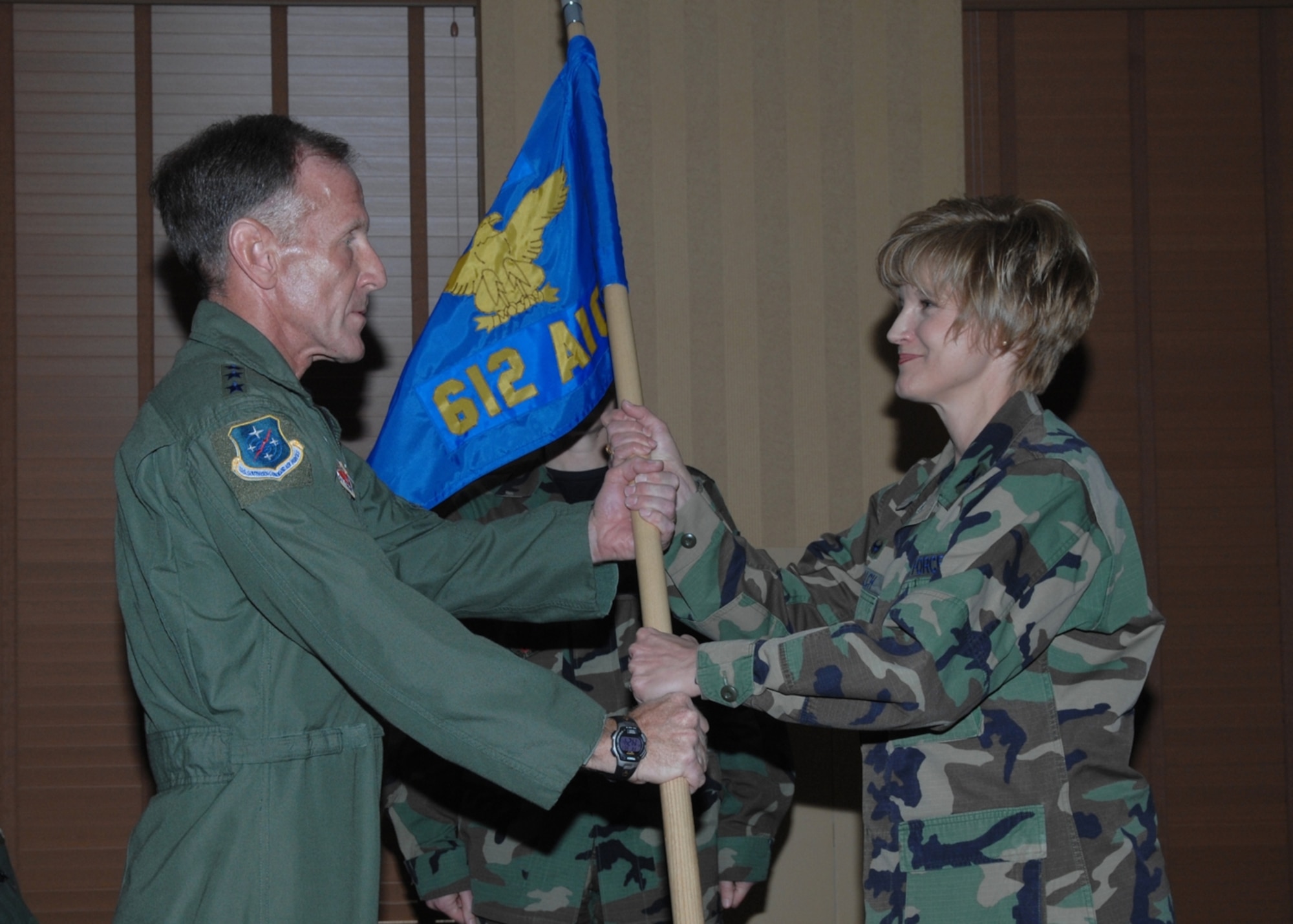 Col. Margaret Schalch (right), the Commander, 612th Air Intelligence Group, relinquishes command to Lt. Gen. Norman Seip, the Commander, 12th Air Force (Air Forces Southern) during an inactivation and redesignation ceremony Feb. 29 at Davis-Monthan Air Force Base, Ariz. The 612th Air Intelligence Group was deactivated, and reactivated as the 12th AF (AFSOUTH) A-2 Division with Colonel Schalch as the commander. 