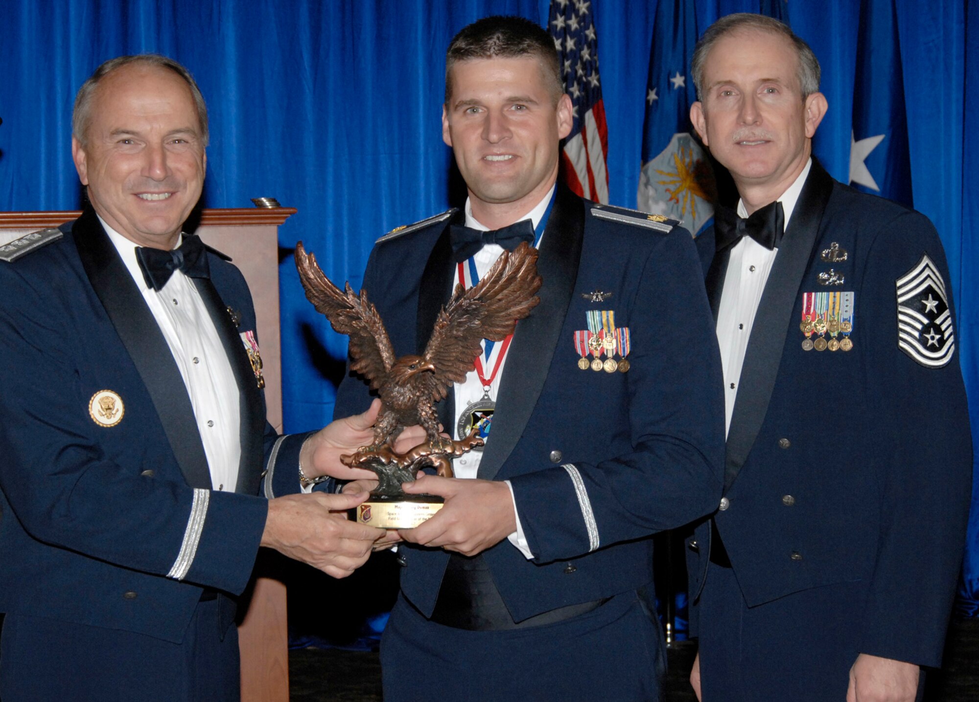 Field Grade Officer of the Year was presented to Maj. Craig Dumas. Also pictured is SMC Commander Lt. Gen.  Michael Hamel and SMC Command Chief Master Sergeant Steven Crocker. (Photo by Lou Hernandez)
