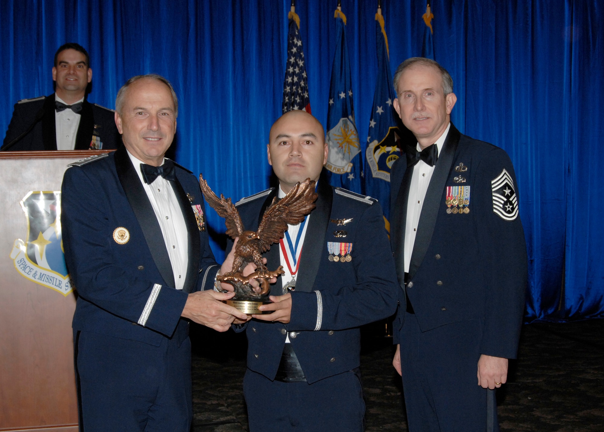 Junior Company Grade Officer of the Year was presented to First Lt John Gomez. Also pictured is SMC Commander Lt. Gen.  Michael Hamel and SMC Command Chief Master Sergeant Steven Crocker. (Photo by Lou Hernandez)