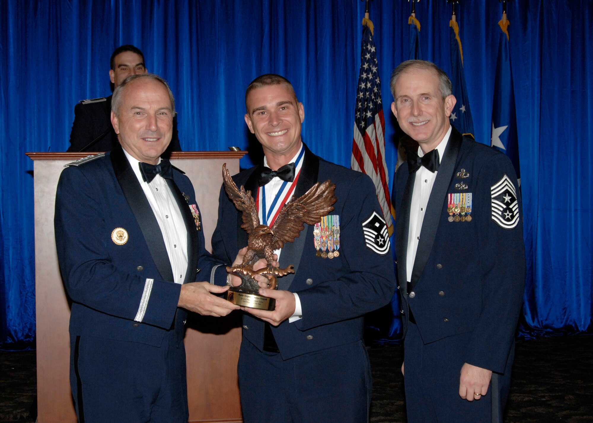 First Sergeant of the Year was presented to Master Sgt Thomas Raupach.  Also pictured is SMC Commander Lt. Gen.  Michael Hamel and SMC Command Chief Master Sergeant Steven Crocker. (Photo by Lou Hernandez)
