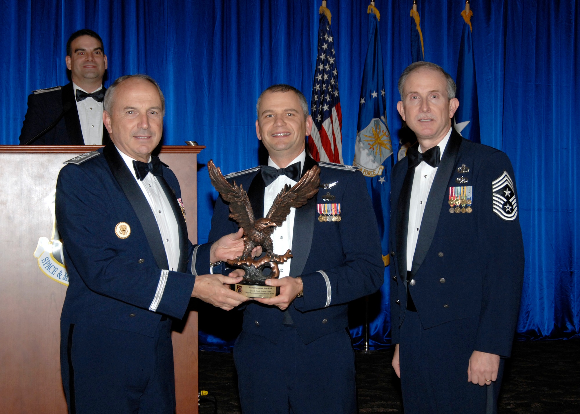 Lt. Col. Bruno Mediate accepted the Senior Noncommissioned Officer of the Year Staff Award on behalf of Master Sgt Scott Ward, who is currently deployed. Also pictured is SMC Commander Lt. Gen.  Michael Hamel and SMC Command Chief Master Sergeant Steven Crocker. (Photo by Lou Hernandez)