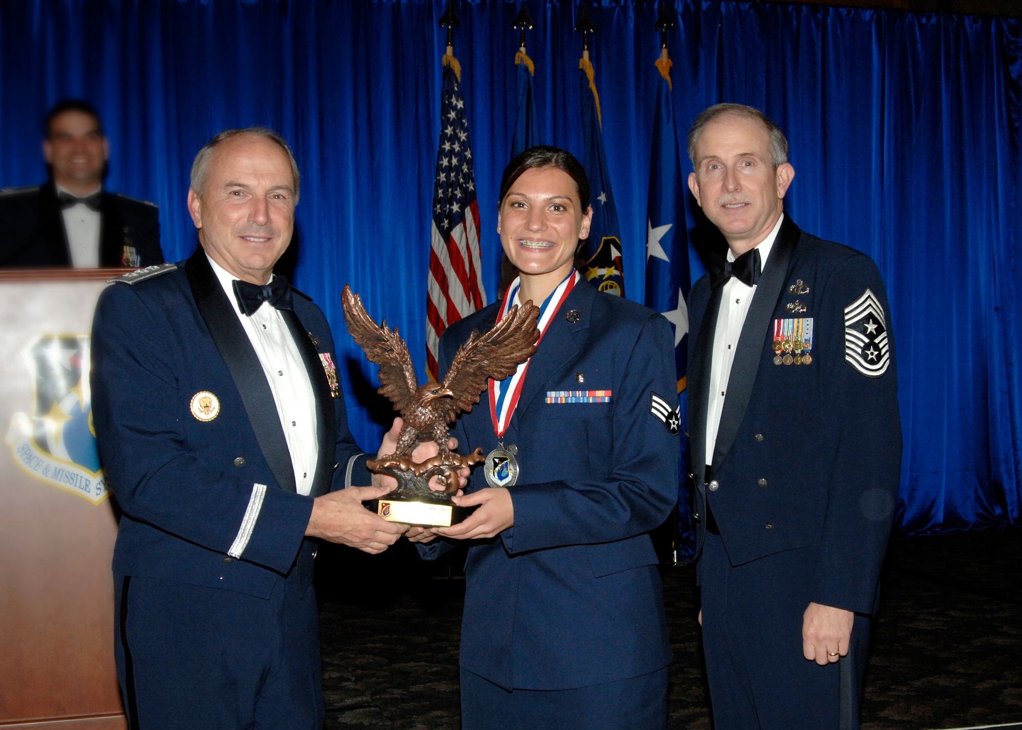 Airman of the Year was presented to Senior Airman Amanda Gladle. Also pictured is SMC Commander Lt. Gen.  Michael Hamel and SMC Command Chief Master Sergeant Steven Crocker. (Photo by Lou Hernandez)