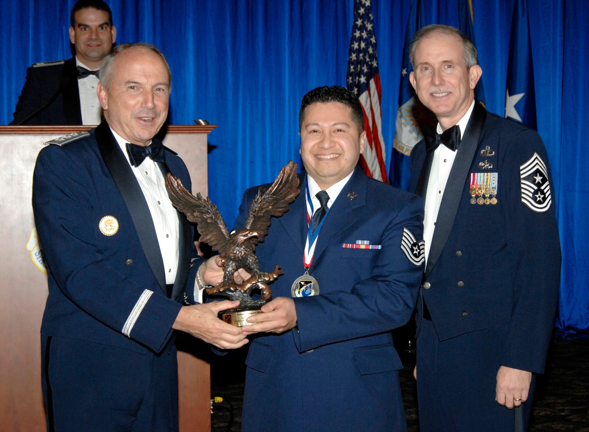 Enlisted Individual Mobilization Augmentee of the Year was presented to Tech Sgt Edward Castro. Also pictured is SMC Commander Lt. Gen.  Michael Hamel and SMC Command Chief Master Sergeant Steven Crocker. (Photo by Lou Hernandez)