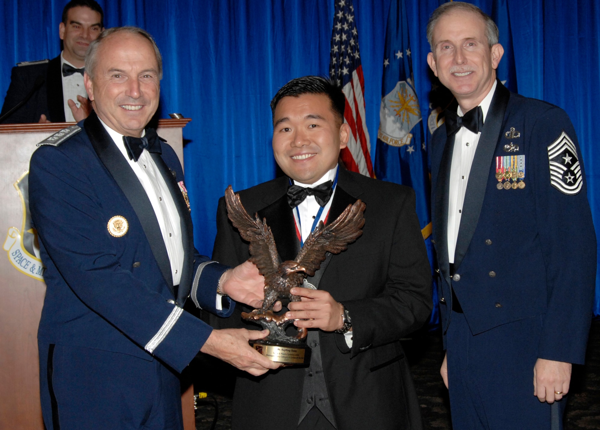 Non-supervisory Category II Civilian of the Year was presented to Rayming Chang. Also pictured is SMC Commander Lt. Gen.  Michael Hamel and SMC Command Chief Master Sergeant Steven Crocker. (Photo by Lou Hernandez) 