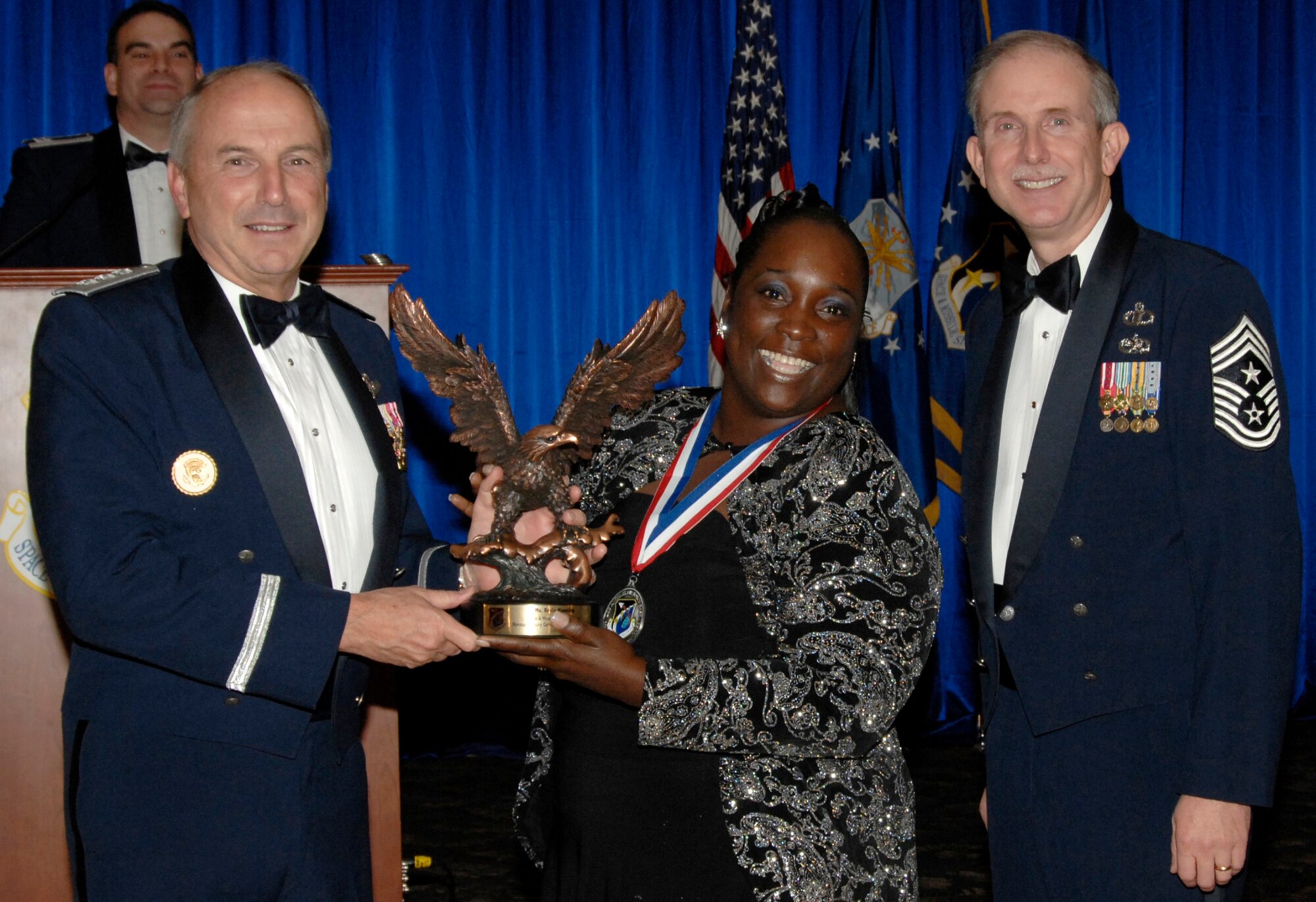Non-supervisory Category I Civilian of the Year was presented to Rosie Manning. Also pictured is SMC Commander Lt. Gen.  Michael Hamel and SMC Command Chief Master Sergeant Steven Crocker. (Photo by Lou Hernandez)