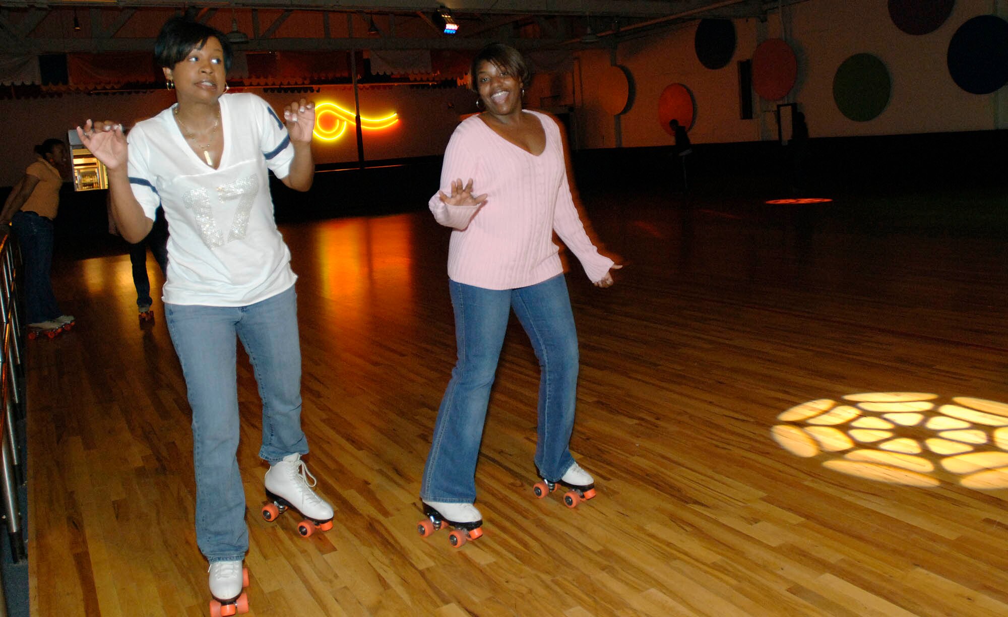 FAIRCHILD AIR FORCE BASE, Wash. – Tech. Sgt. Teresa Tillman and Tech. Sgt. Michele Glaspie, both from the 92nd Air Refueling Wing, enjoy skating at the base skating rink on Feb. 28. The first sergeants sponsored a skate night to foster base morale. The skate night also including a spade and dominoes tournament. (U.S. Air Force photo/Staff Sgt. JT May III)