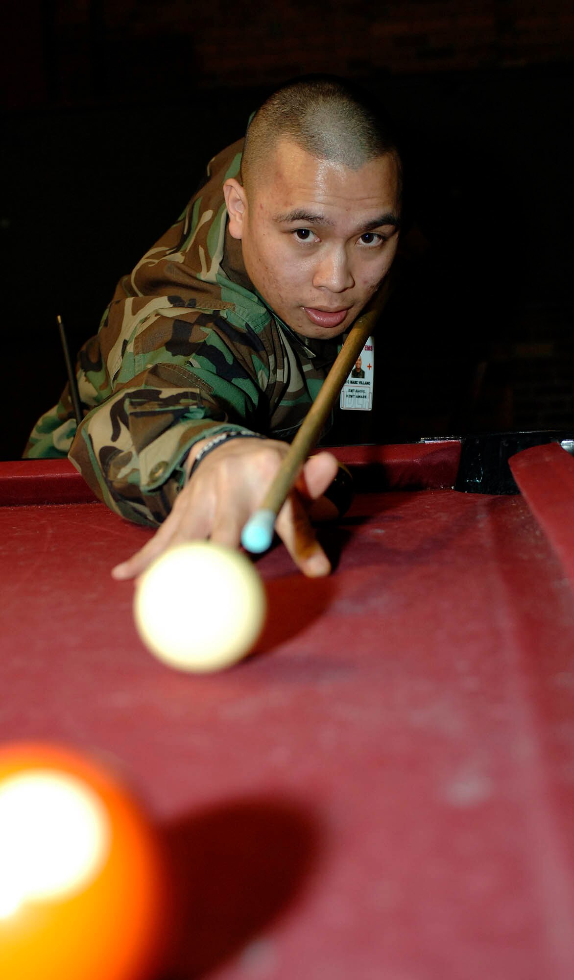 FAIRCHILD AIR FORCE BASE, Wash. – Airman 1st Class Eric Carter, 92nd Civil Engineer Squadron electrician, prepares to take a shot during a pool game on Feb. 28. The first sergeants sponsored a skate night at the base skating rink to increase base morale. (U.S. Air Force photo/Staff Sgt. JT May III)