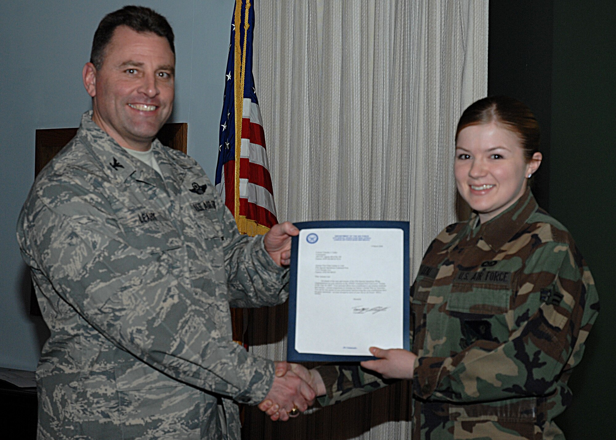 CANNON AIR FORCE BASE, N.M.-- Airman 1st Class Lauren Leal, 27th Special Operations Wing command post, receives the Command Post Unit-Level Airman of the Year Award from Col. Timothy Leahy, 27th Special Operations Wing commander.  The presentation took place March 4 at wing headquarters during the weekly staff meeting. (U.S. Air Force photo/Airman 1st Class Evelyn Chavez)