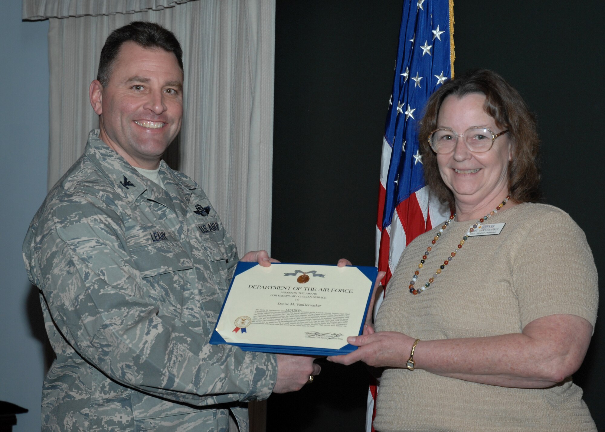CANNON AIR FORCE BASE, N.M.-- Denise Vanderwarker receives the Exemplary Civilian Service Award from Col. Timothy Leahy, 27th Special Operations Wing commander. The presentation took place March 4 at wing headquarters during the weekly staff meeting. (U.S. Air Force photo/Airman 1st Class Evelyn Chavez)