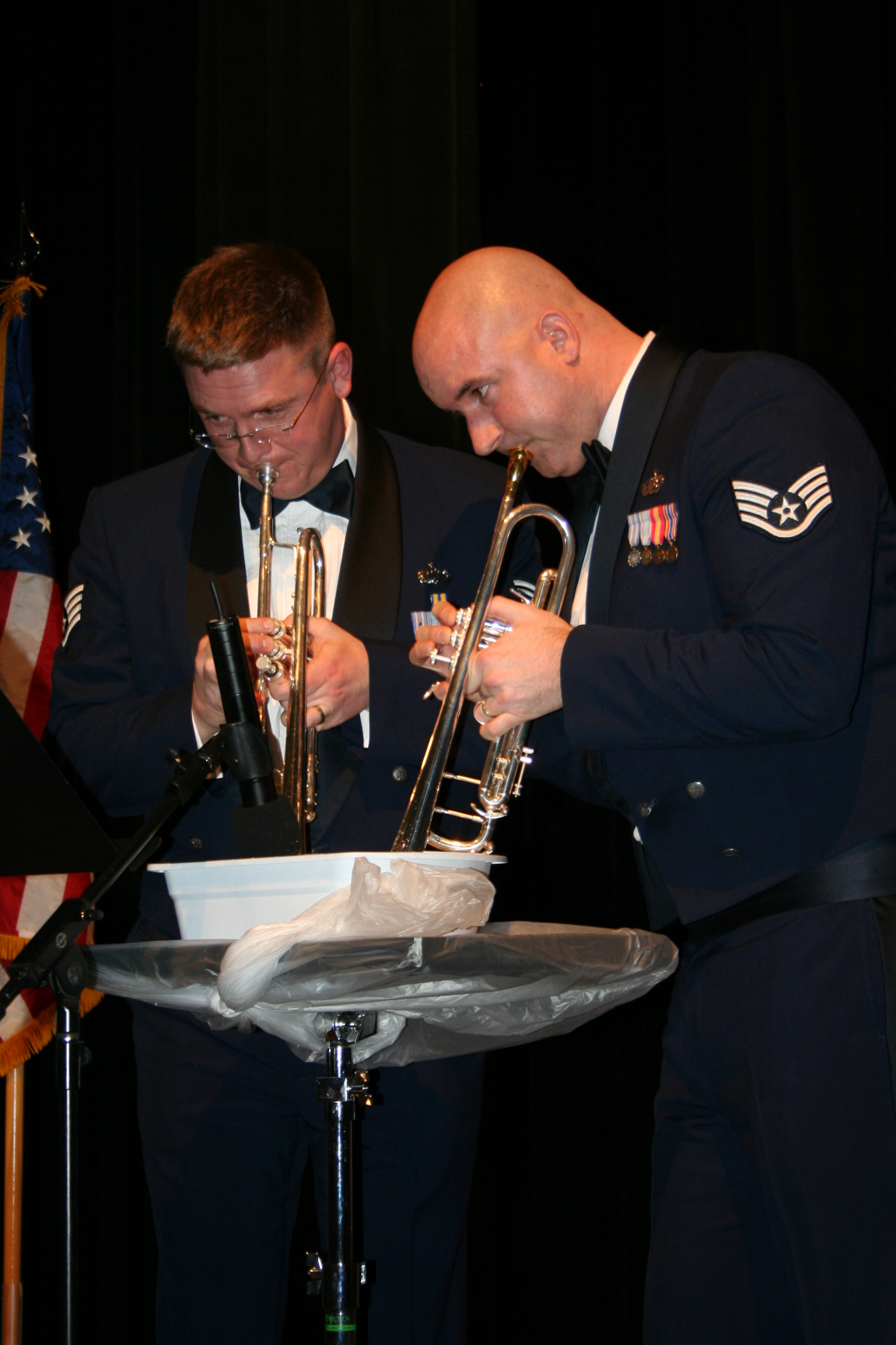 Staff Sgts. Jeff Reich and Eric Proper imitated the sound of a mandolin by playing into water during Brass in Blue's rendition of 'Belle Notte' from Disney's 'Lady and the Tramp.'  This was one of the group's romantic pieces performed in honor of Valentine's Day as they toured Minnesota in February 2008.