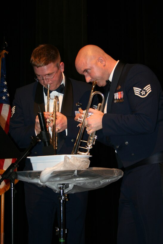Staff Sgts. Jeff Reich and Eric Proper imitated the sound of a mandolin by playing into water during Brass in Blue's rendition of 'Belle Notte' from Disney's 'Lady and the Tramp.'  This was one of the group's romantic pieces performed in honor of Valentine's Day as they toured Minnesota in February 2008.