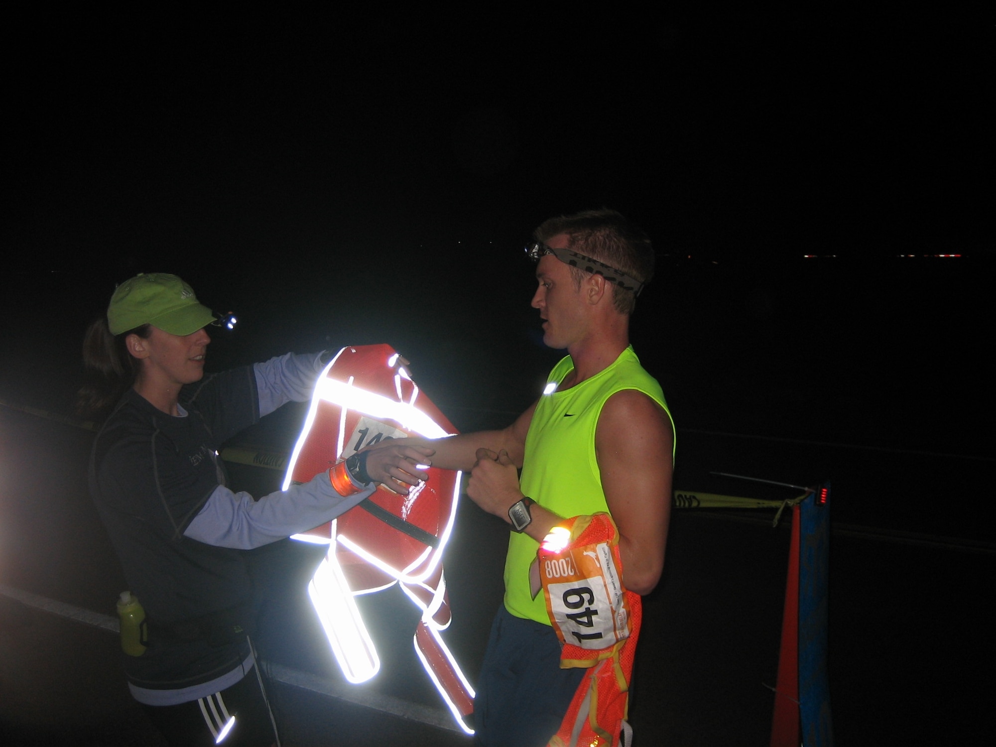 1st Lt. Elithe Zoglman, left, hands the relay baton to 1st Lt. Joshua Singsaas during the Ragnar Relay del Sol race from Wickenburg to Mesa, Ariz. The team finished the 182-mile relay race in 23 hours 44 minutes. (Courtesy photo)