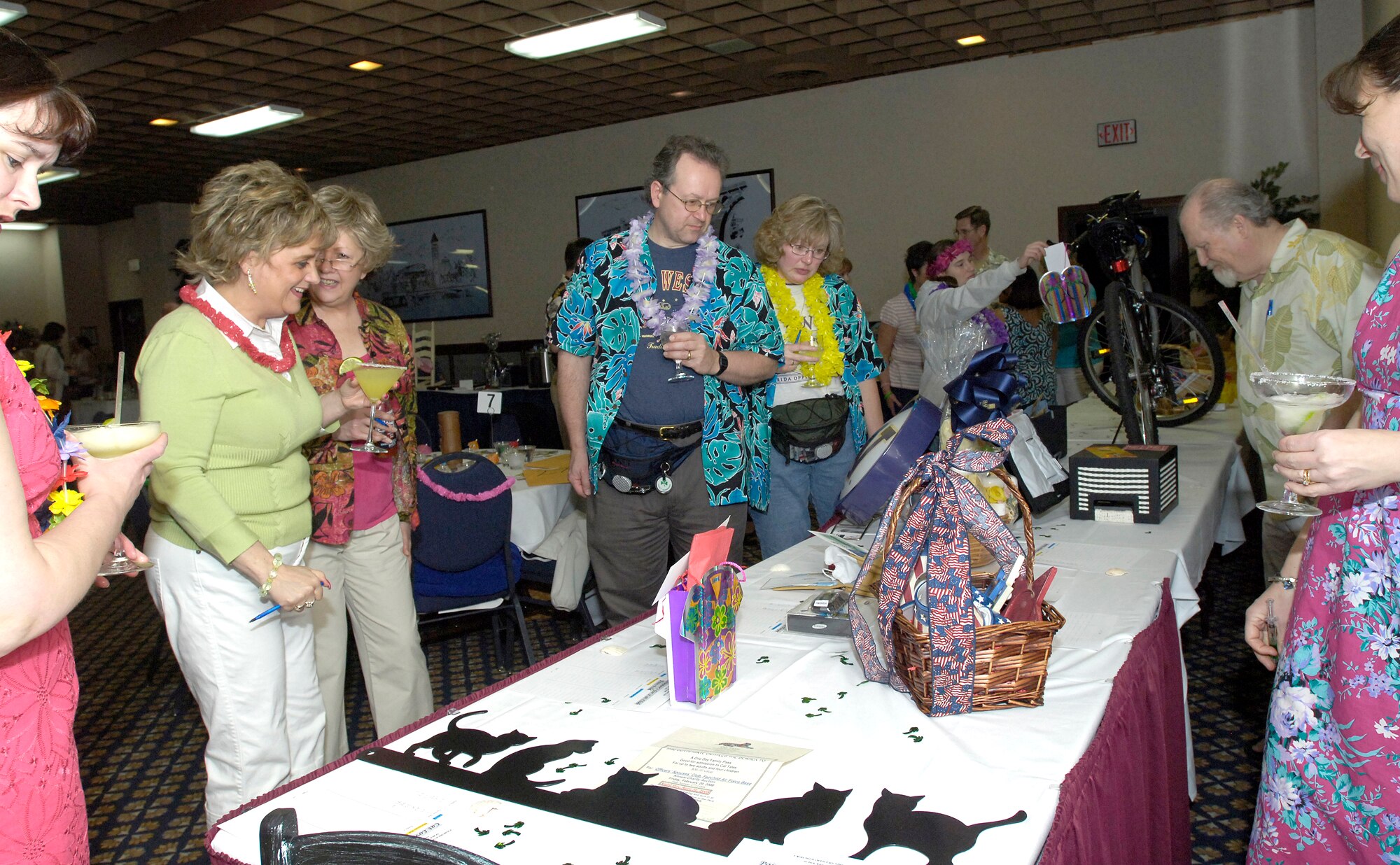 FAIRCHILD AIR FORCE BASE, Wash. – Members of Team Fairchild and the Spokane community take some time to browse the items for bid at the Officer’s Spouses Club Margaritaville Charity Auction on Feb. 29 at Club Fairchild. The auction raised $16,481 in charitable contributions for scholarships to be awarded to spouses and children of military members. (U.S. Air Force photo/Senior Airman Eunique Stevens)