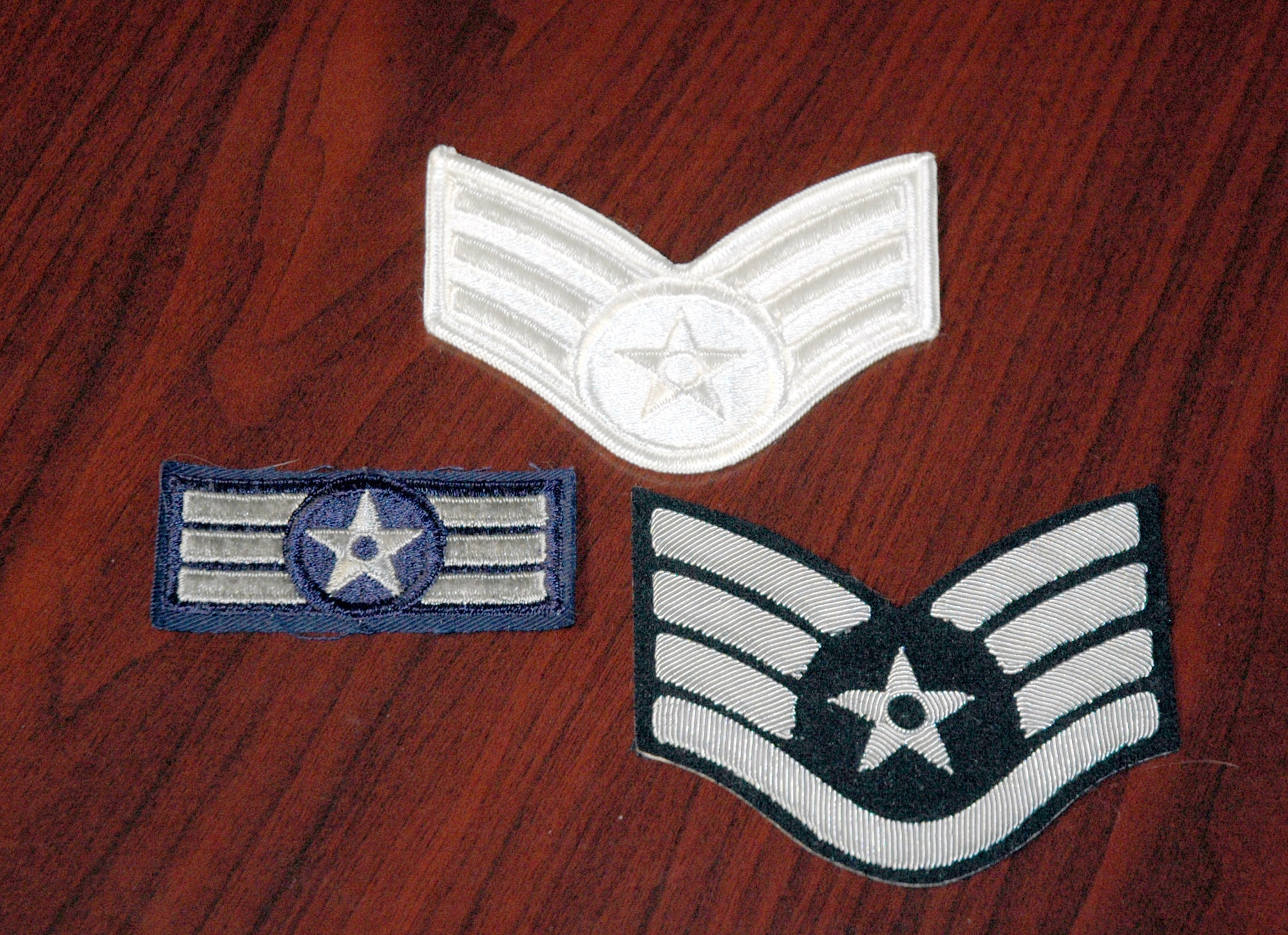 (Top to bottom) A ceremonial white Air Force chevron worn on a white service dress uniform in the 1970s; Airman first class horizontal striped chevron from the 1950s that never made it into existence; and a NCO black mess dress chevron from the early 1980s. This collection belongs to Chief Master Sgt. Jerry Hanes, 341st Operations Group interim-superintendent, who has an extensive military memorabilia collection ranging from uniforms, patches, collar brass, framed photos and documents to name a few. He has been collecting for 35 years. (U.S. Air Force photo/Senior Airman Eydie Sakura)