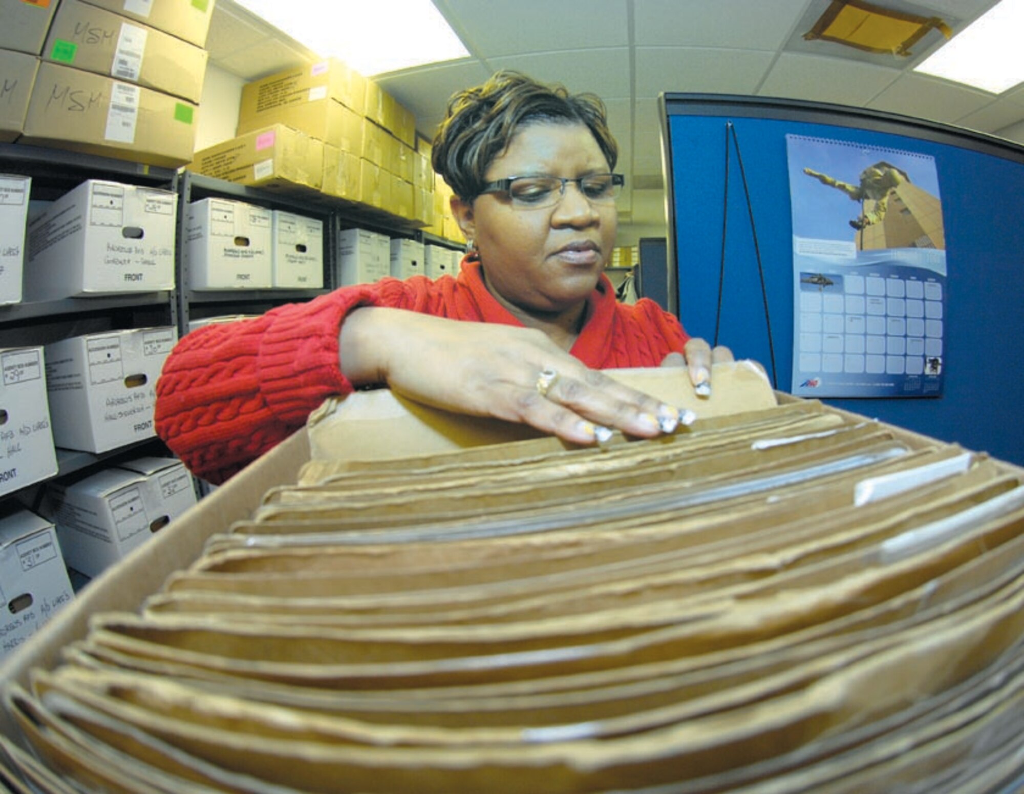 Marshell Johnson sorts through records before closing the box in preparation for the shipment to AFPC. Each record has been checked several times in the last year for accuracy. Unit Personnel Record Groups are being relocated to Randolph Air Force Base to be scanned and made electronically available for all active duty personnel.  (US Air Force/SrA Renae Kleckner)
