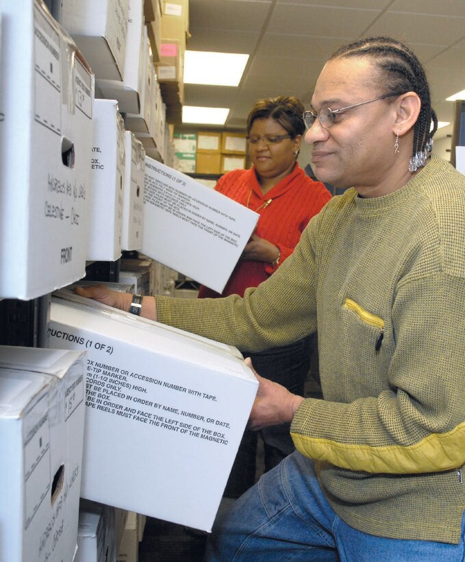 Steven E. James, and Marshell Johnson, human resource assistants with the 316th Military Personnel Flight, move boxes as they prepare to move records on Feb. 14. Unit Personnel Record Groups are being relocated to Randolph Air Force Base to be scanned and made electronically available for all active duty personnel.  (US Air Force/SrA Renae Kleckner)