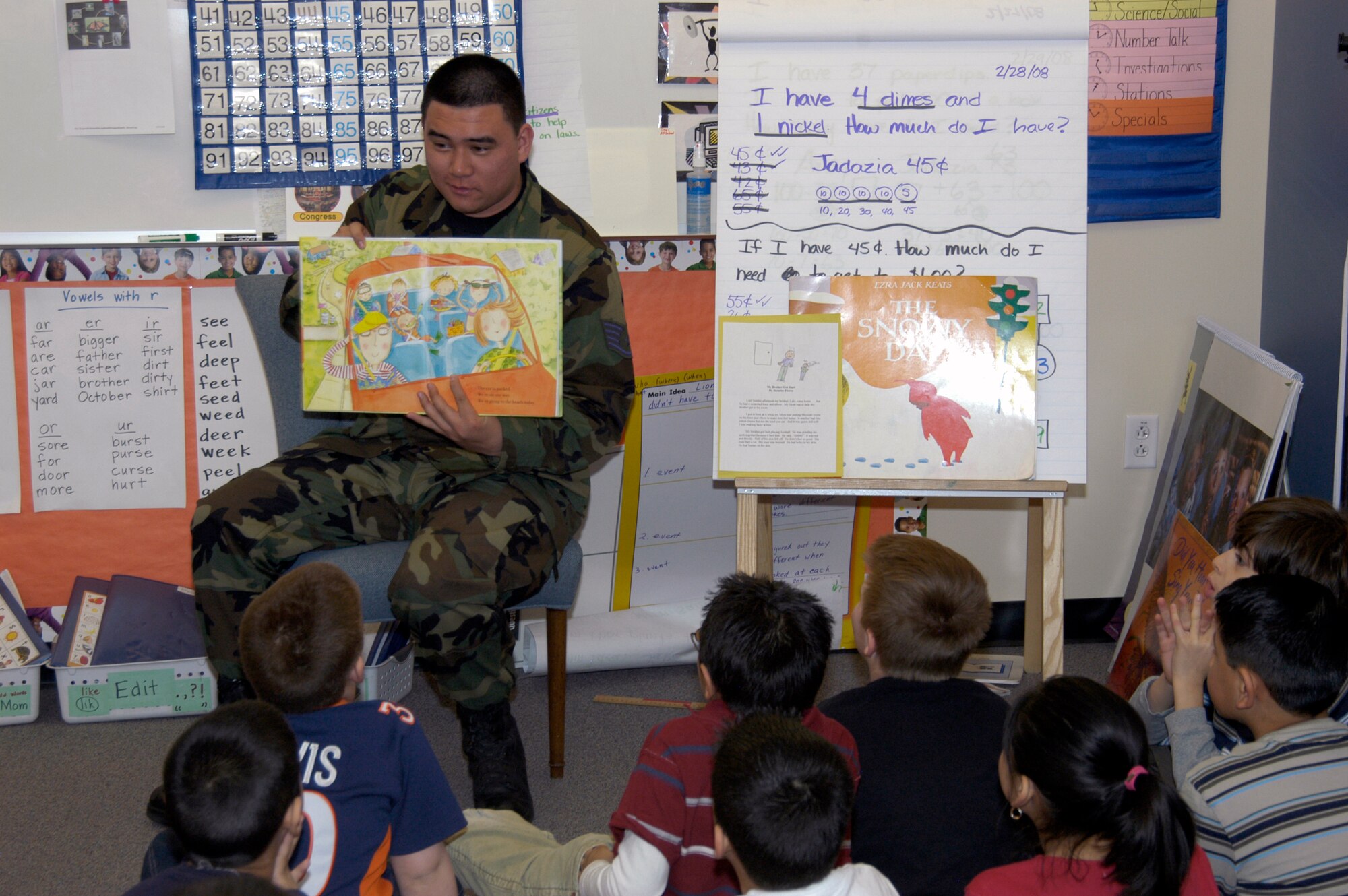 Staff Sgt. Stephen Duerkop, DPS, reads to second graders at Sixth Avenue Elementary in Aurora, Colo. Twenty-five volunteers from the Air Reserve Personnel Center participated in the National Education Association's Read Across America program March 3. The annual event is designed to motivate and teach children about the importance of reading. The event began in 1998 and has been held every year on or around the birthday of children's book author Dr. Seuss. (U.S. Air Force photo/Mike Molina) 