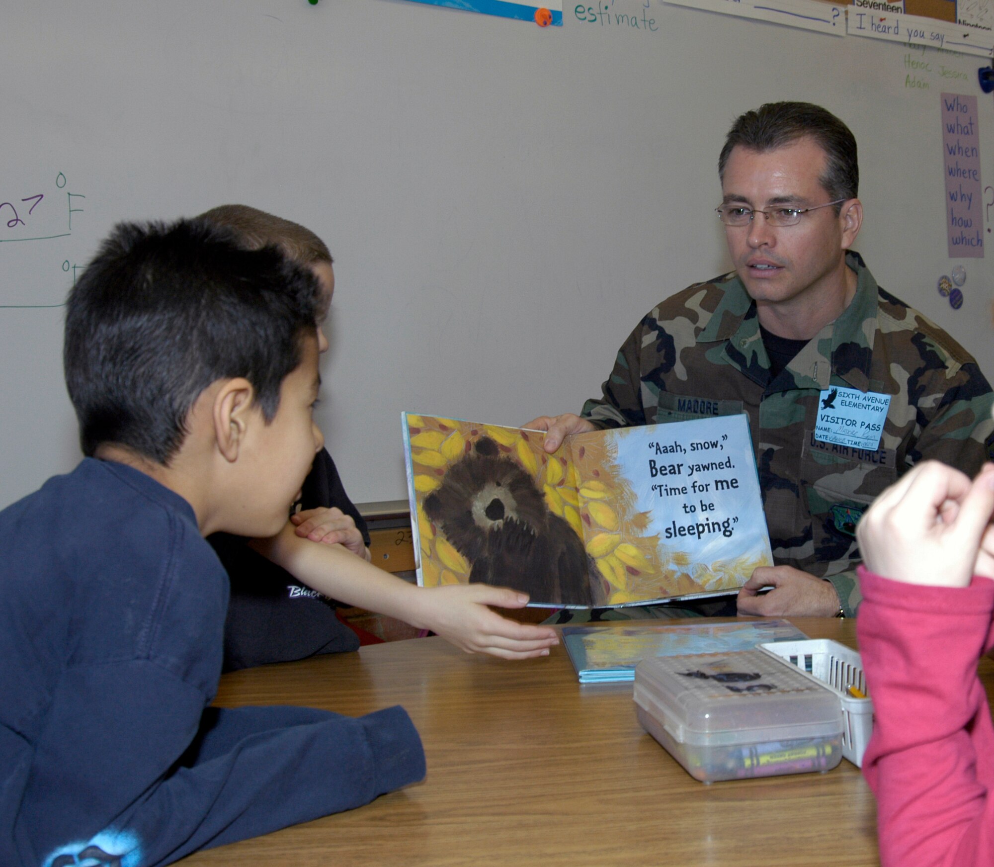 Master Sgt. Roger Madore, DPS, reads to second graders at Sixth Avenue Elementary in Aurora, Colo. Twenty-five volunteers from the Air Reserve Personnel Center participated in the National Education Association's Read Across America program March 3. The annual event is designed to motivate and teach children about the importance of reading. The event began in 1998 and has been held every year on or around the birthday of children's book author Dr. Seuss. (U.S. Air Force photo/Mike Molina) 