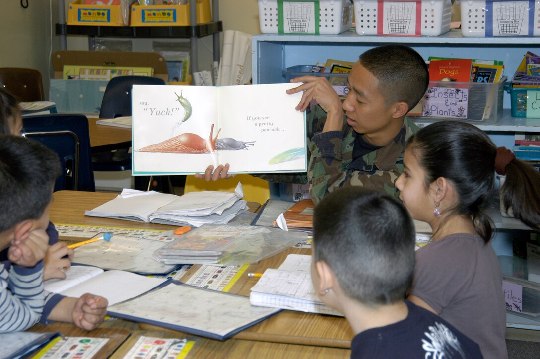 Airman Joselito Santiago, DPS, reads to second graders at Sixth Avenue Elementary in Aurora, Colo. Twenty-five volunteers from the Air Reserve Personnel Center participated in the National Education Association's Read Across America program March 3. The annual event is designed to motivate and teach children about the importance of reading. The event began in 1998 and has been held every year on or around the birthday of children's book author Dr. Seuss. (U.S. Air Force photo/Mike Molina) 