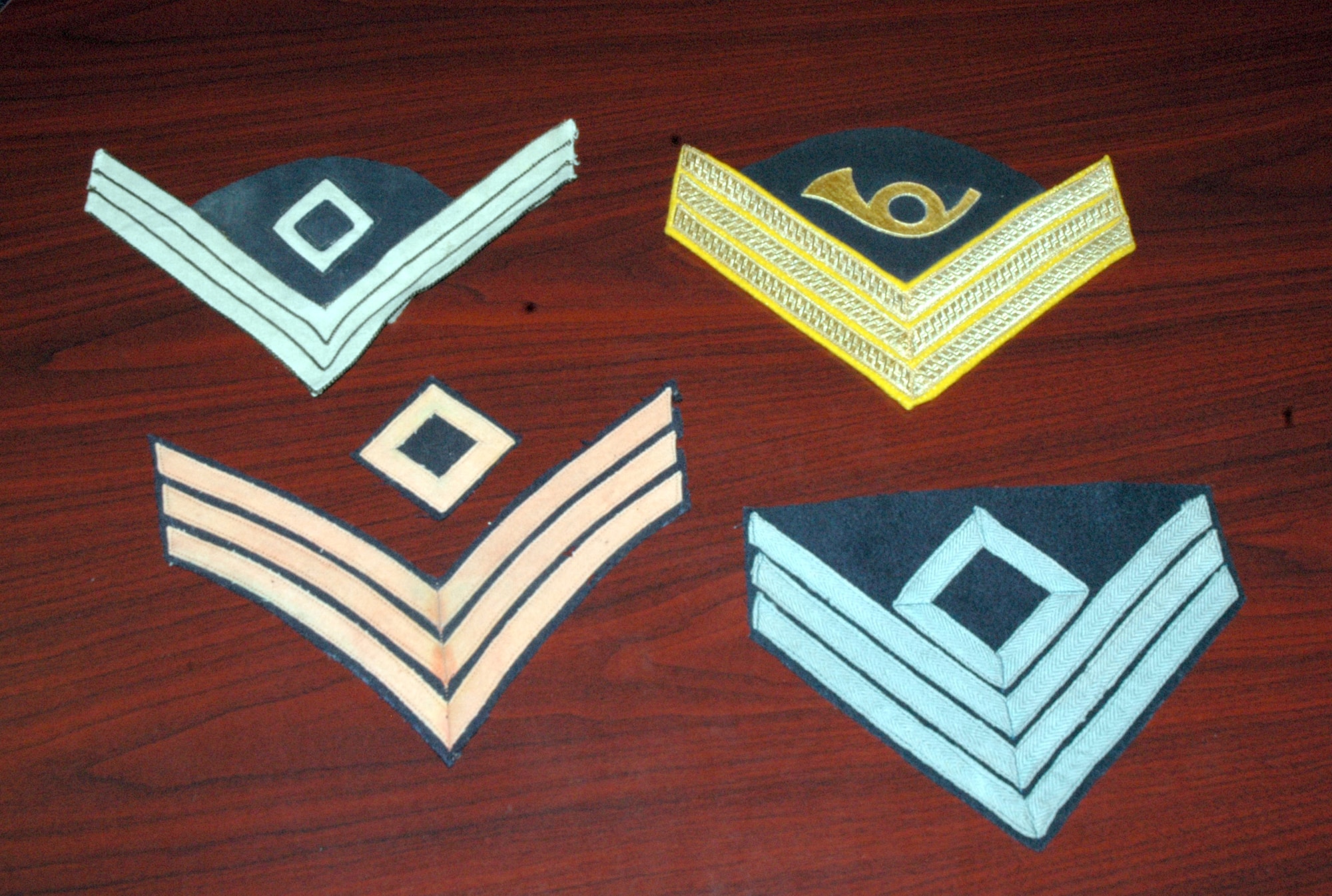Chief Master Sgt. Jerry Hanes, 341st Operations Group interim superintendent, has an extensive collection of military memorabilia ranging from before the Civil War to present. He especially enjoys collecting first sergeant insignia and this picture shows insignia from an infantry first sergeant from the Spanish-American War; a principle musician dress uniform insignia from 1884; an 1851 Dragoon (cavalry soldier) first sergeant chevron; and Civil War infantry rank first sergeant from the Union Army. (U.S. Air Force photo/Senior Airman Eydie Sakura)