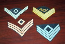 Chief Master Sgt. Jerry Hanes, 341st Operations Group interim superintendent, has an extensive collection of military memorabilia ranging from before the Civil War to present. He especially enjoys collecting first sergeant insignia and this picture shows insignia from an infantry first sergeant from the Spanish-American War; a principle musician dress uniform insignia from 1884; an 1851 Dragoon (cavalry soldier) first sergeant chevron; and Civil War infantry rank first sergeant from the Union Army. (U.S. Air Force photo/Senior Airman Eydie Sakura)